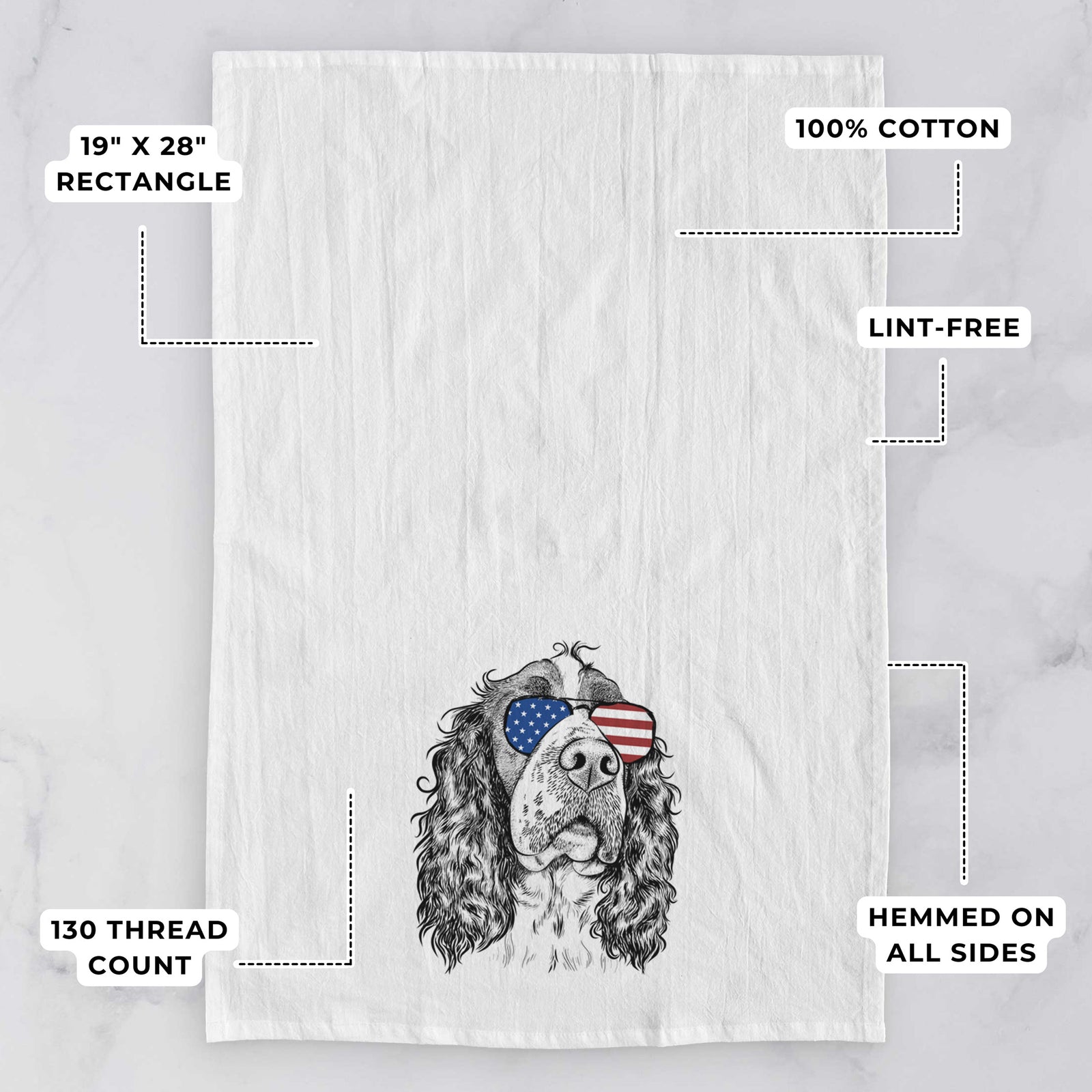 Hand-drawn sketch of Millie Mae the English Springer Spaniel wearing American flag sunglasses on a tea towel, with feature callouts: 19 x 28 inch rectangle, 100% cotton, lint-free, 120 thread count, hemmed on all sides
