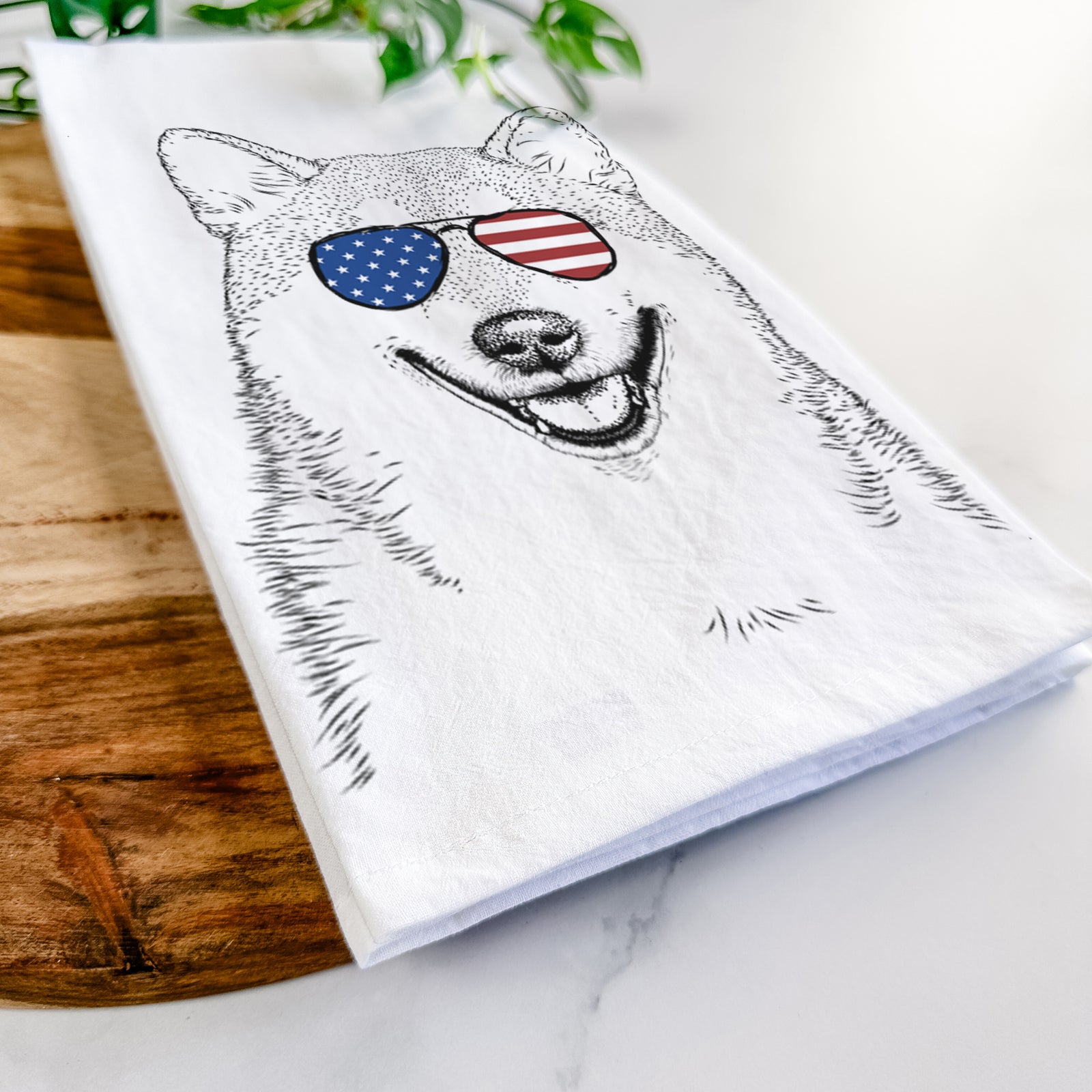 Hand-drawn sketch of Mitsu the Shiba Inu wearing American flag sunglasses on a tea towel