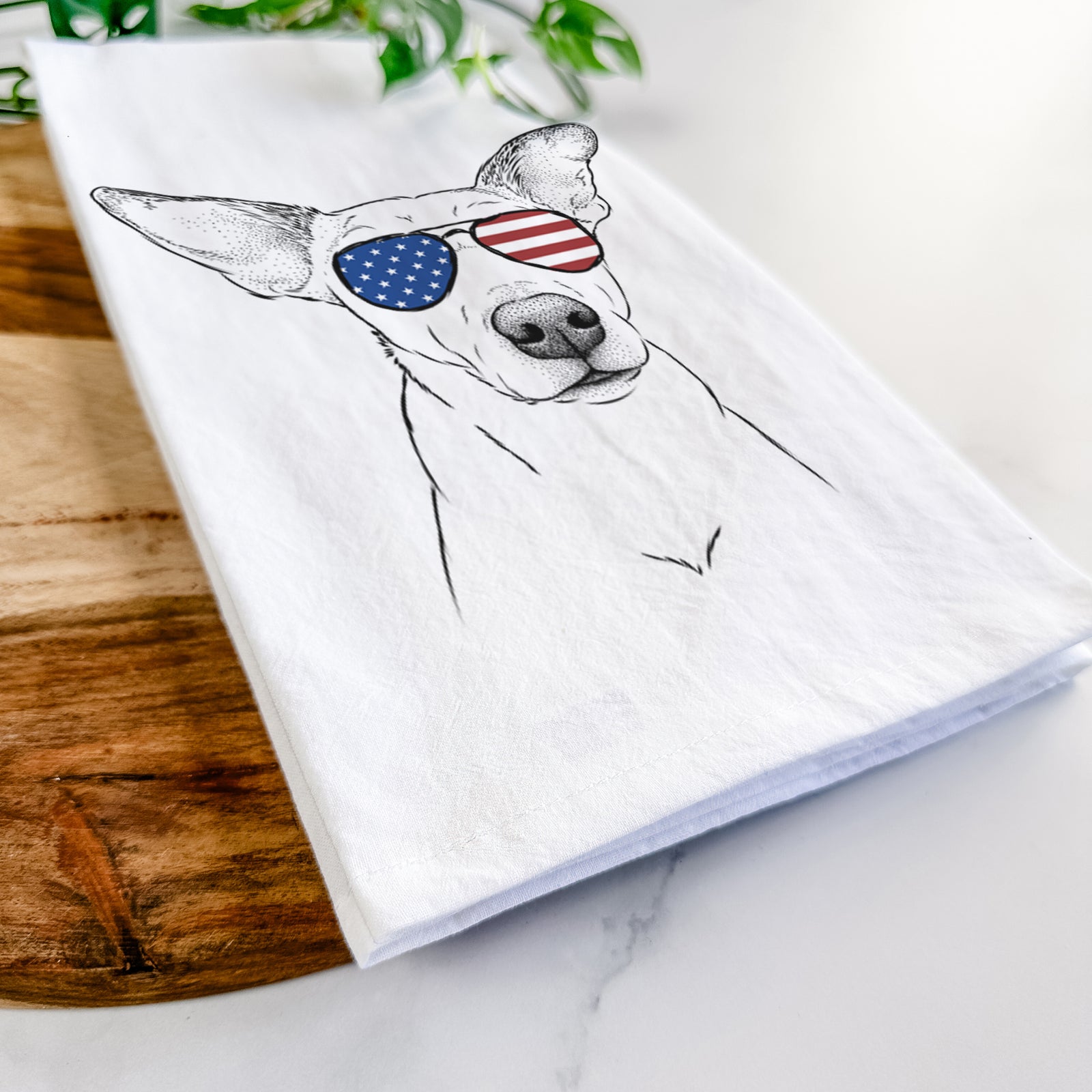 Hand-drawn sketch of Molly the Jack Russell Terrier wearing American flag sunglasses on a tea towel