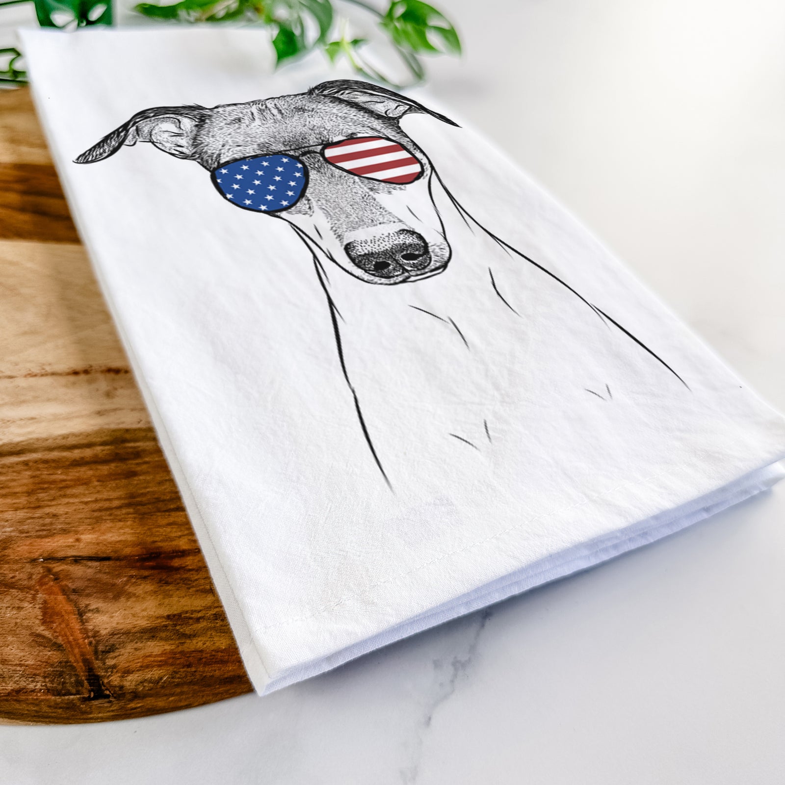 Hand-drawn sketch of Momo the Japanese Terrier wearing American flag sunglasses on a tea towel