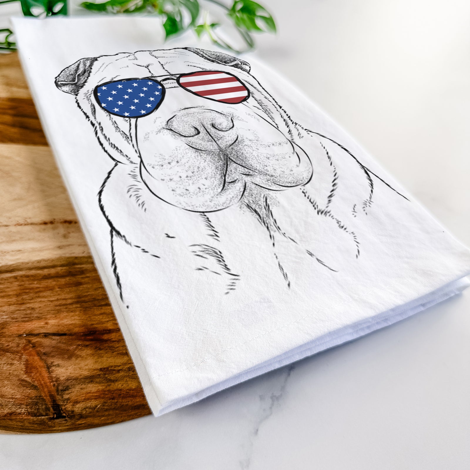 Hand-drawn sketch of Moomers the Shar Pei wearing American flag sunglasses on a tea towel