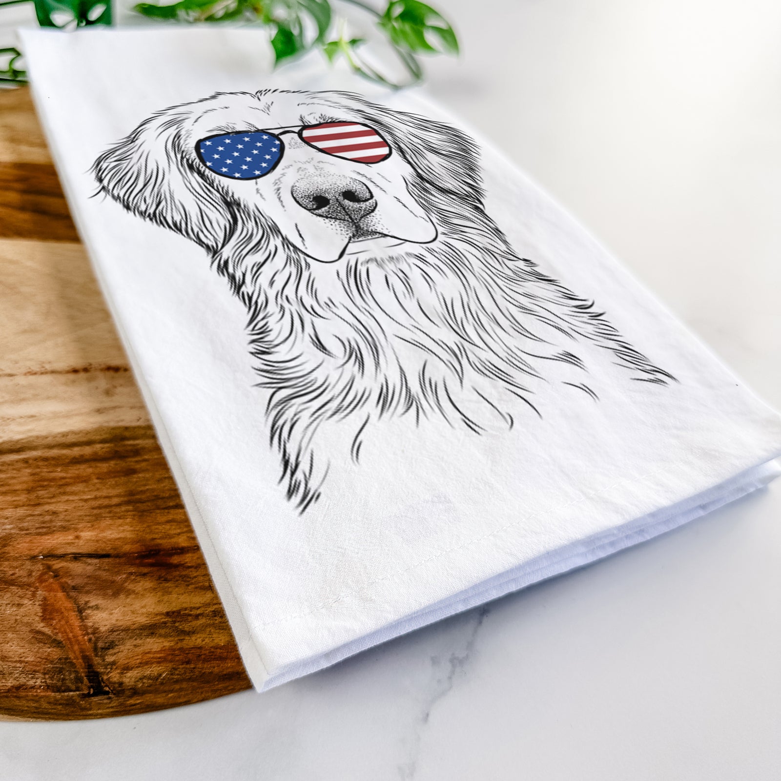 Hand-drawn sketch of Moose the Field Golden Retriever wearing American flag sunglasses on a tea towel