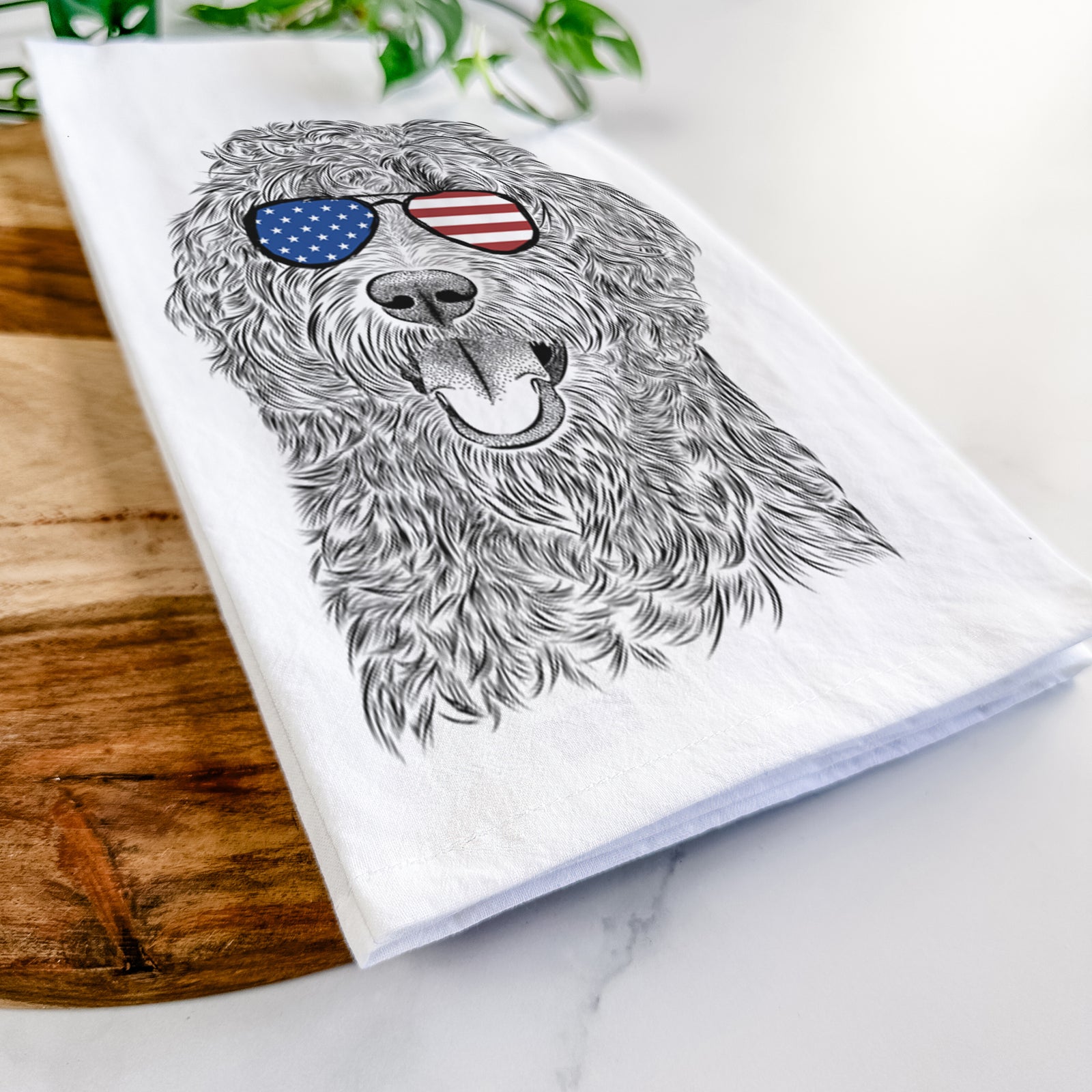 Hand-drawn sketch of Murr Dog the Labradoodle wearing American flag sunglasses on a tea towel
