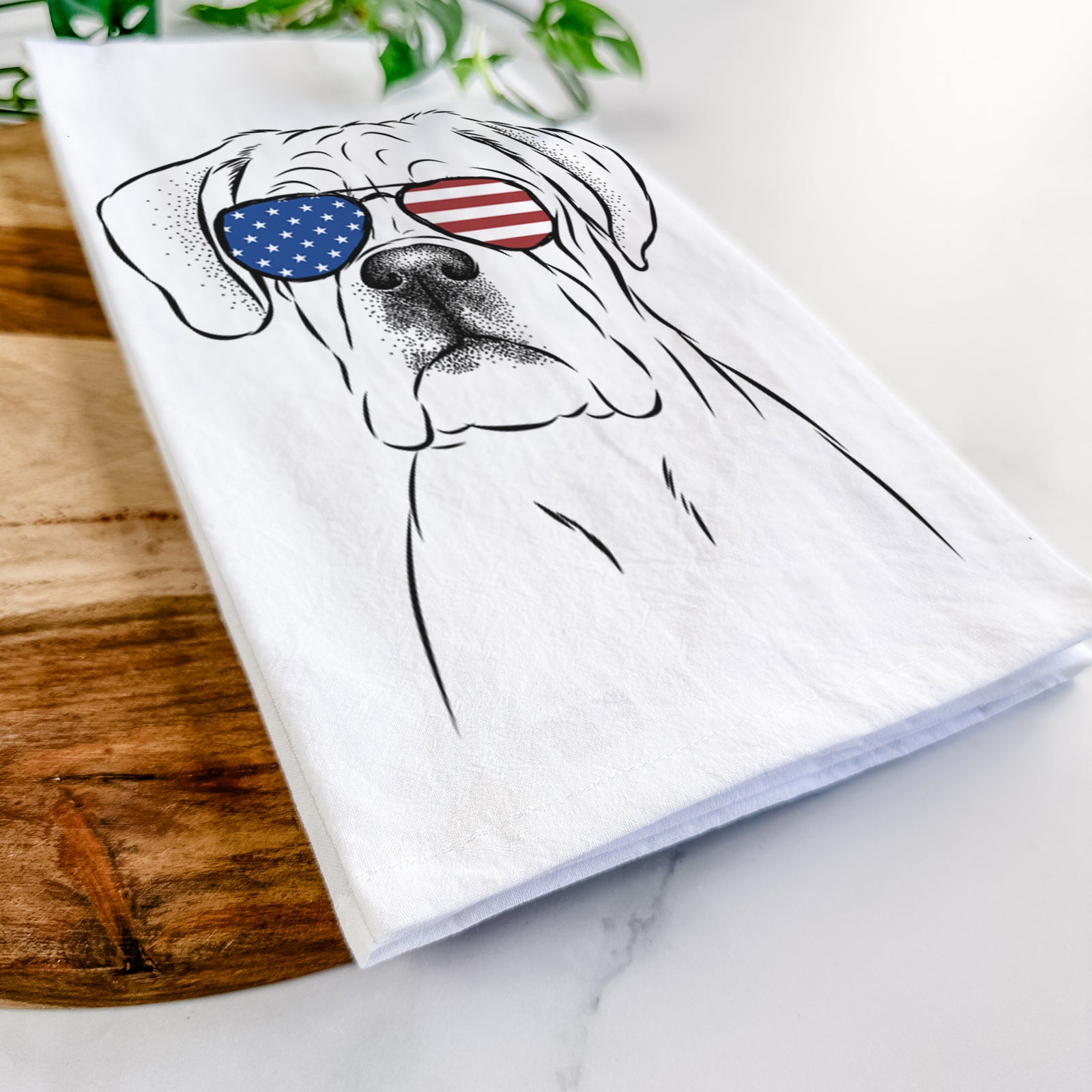 Hand-drawn sketch of Nelly the Boxer wearing American flag sunglasses on a tea towel