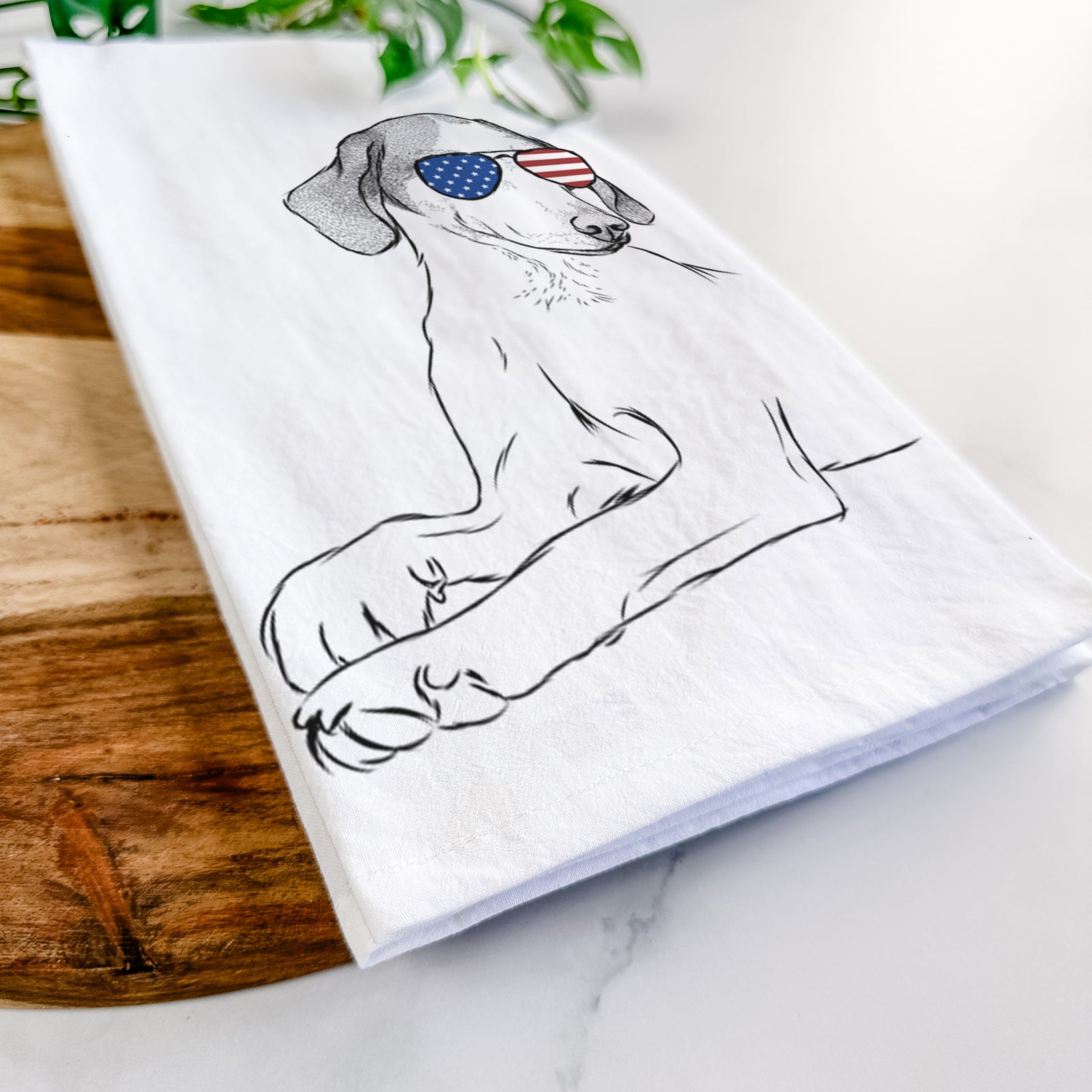Hand-drawn sketch of Opie the Foxhound wearing American flag sunglasses on a tea towel