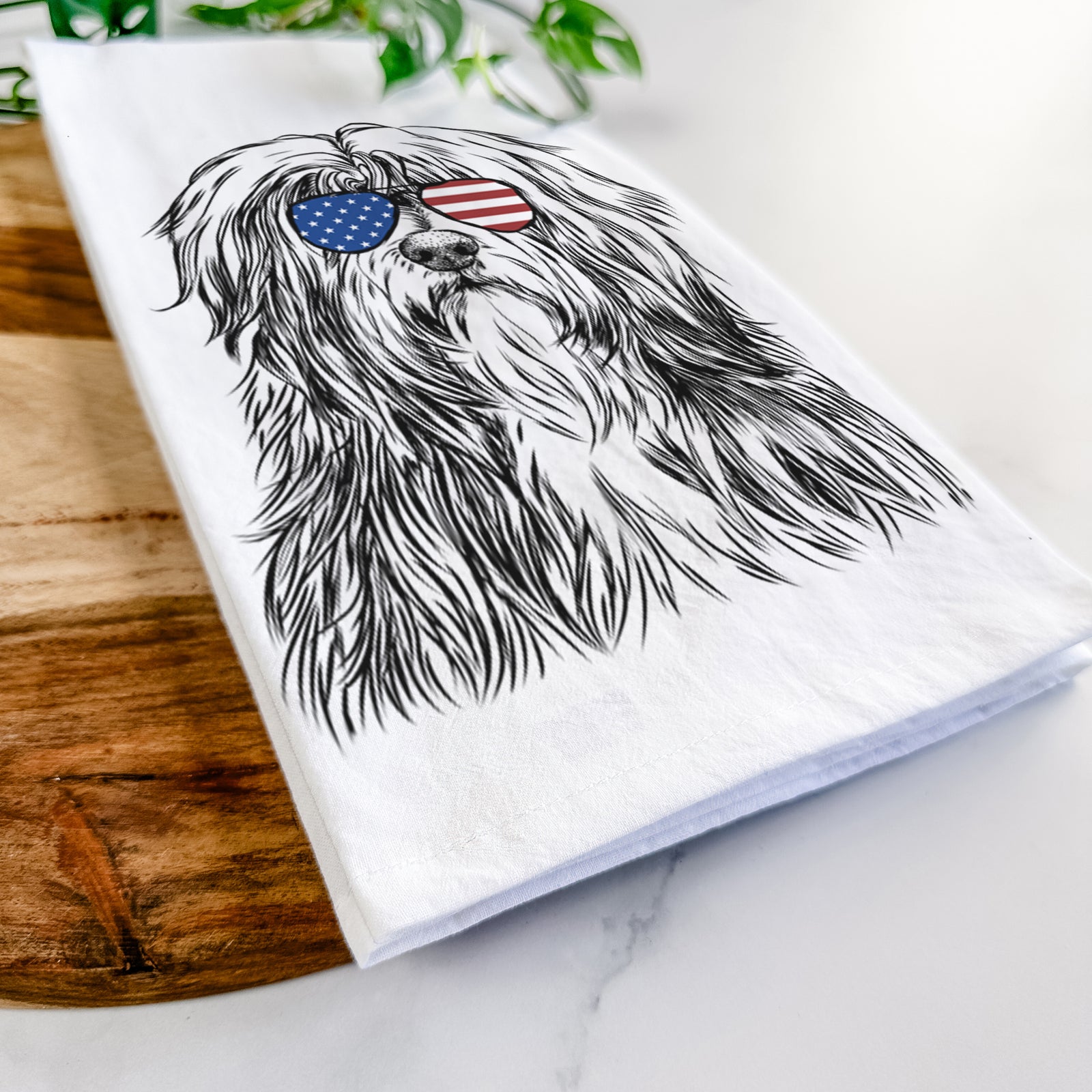 Hand-drawn sketch of Otto the Polish Lowland Sheepdog wearing American flag sunglasses on a tea towel