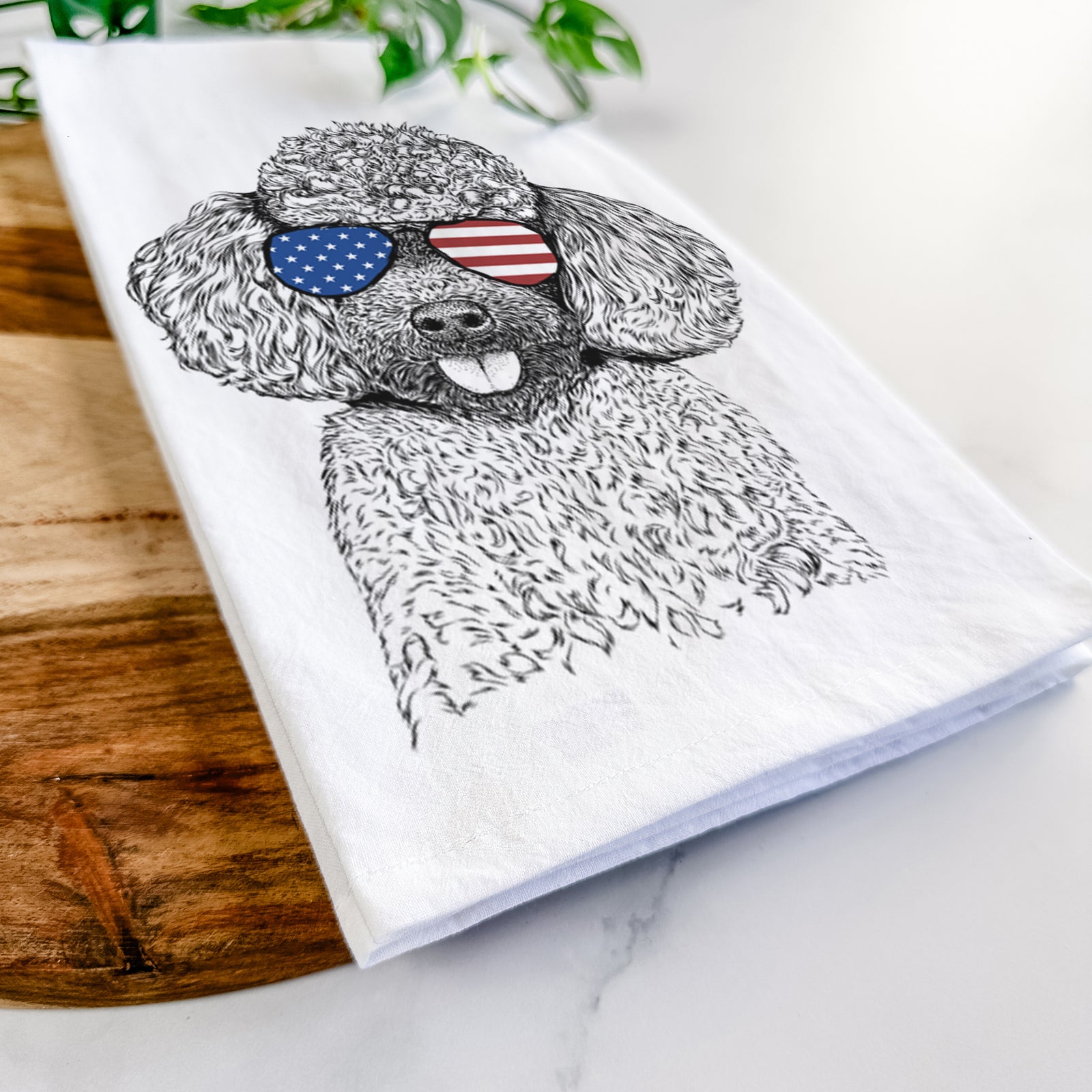 Hand-drawn sketch of George the Toy Poodle wearing American flag sunglasses on a tea towel