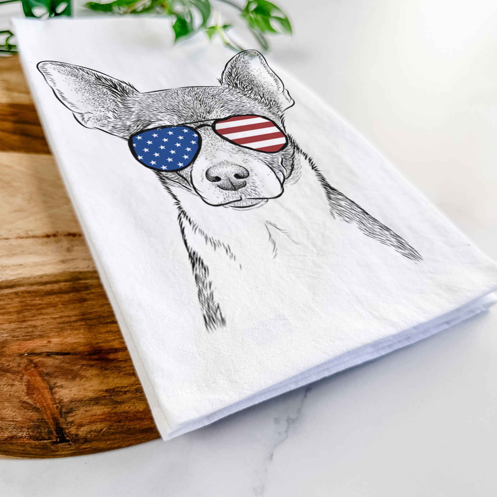 Hand-drawn sketch of Peanut the Chihuahua wearing American flag sunglasses on a tea towel