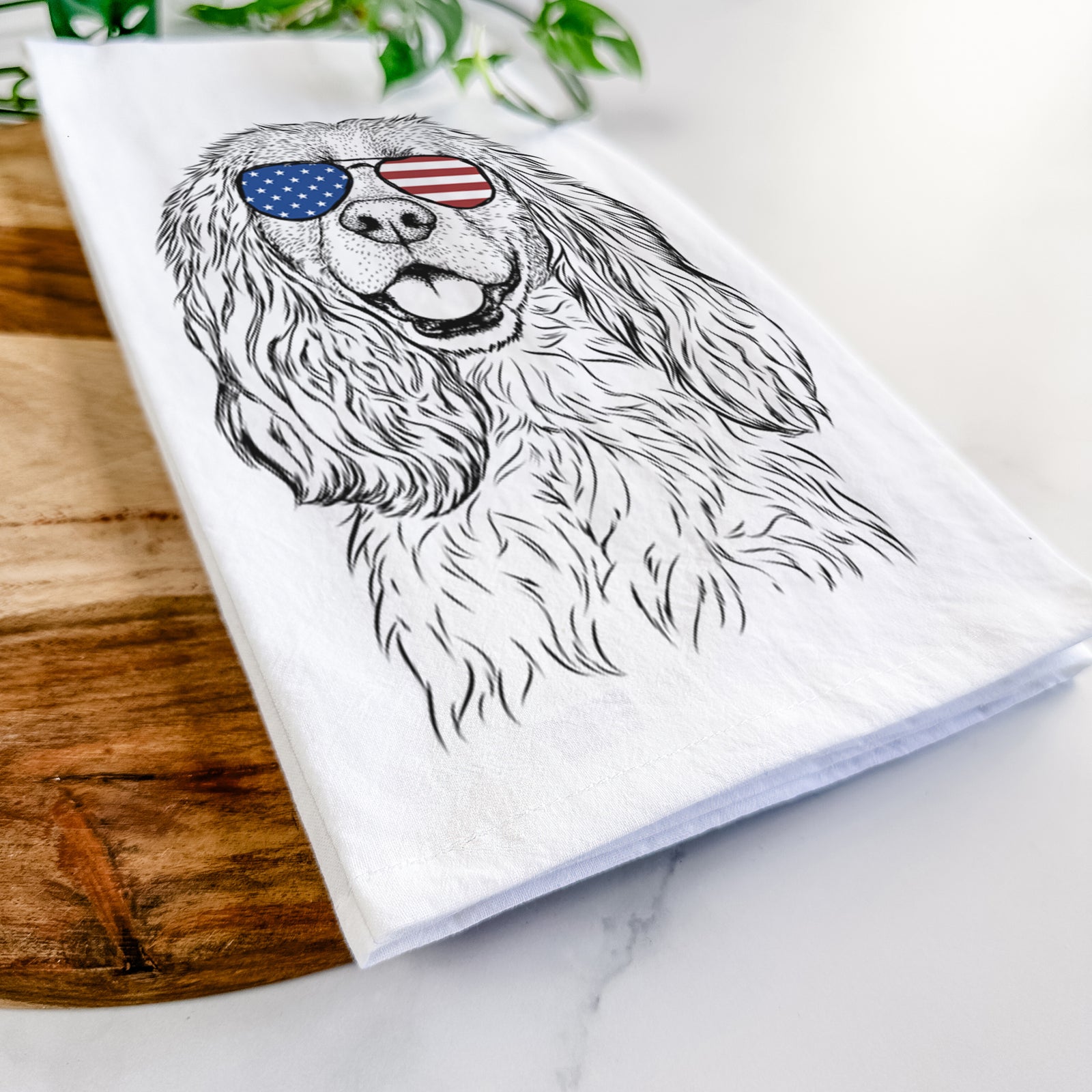 Hand-drawn sketch of Perry the Cockalier wearing American flag sunglasses on a tea towel