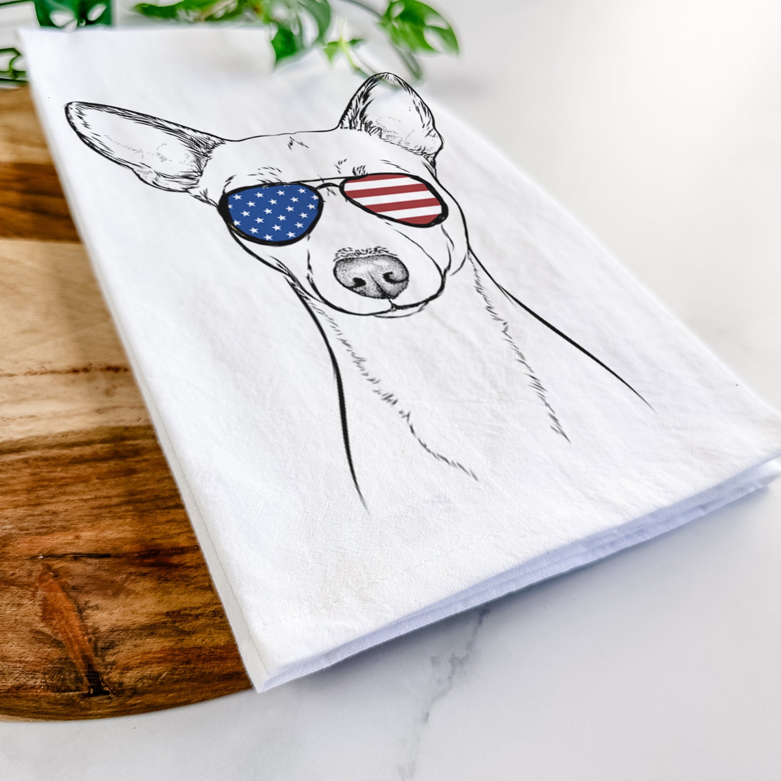 Hand-drawn sketch of Perry the Portuguese Podengo wearing American flag sunglasses on a tea towel