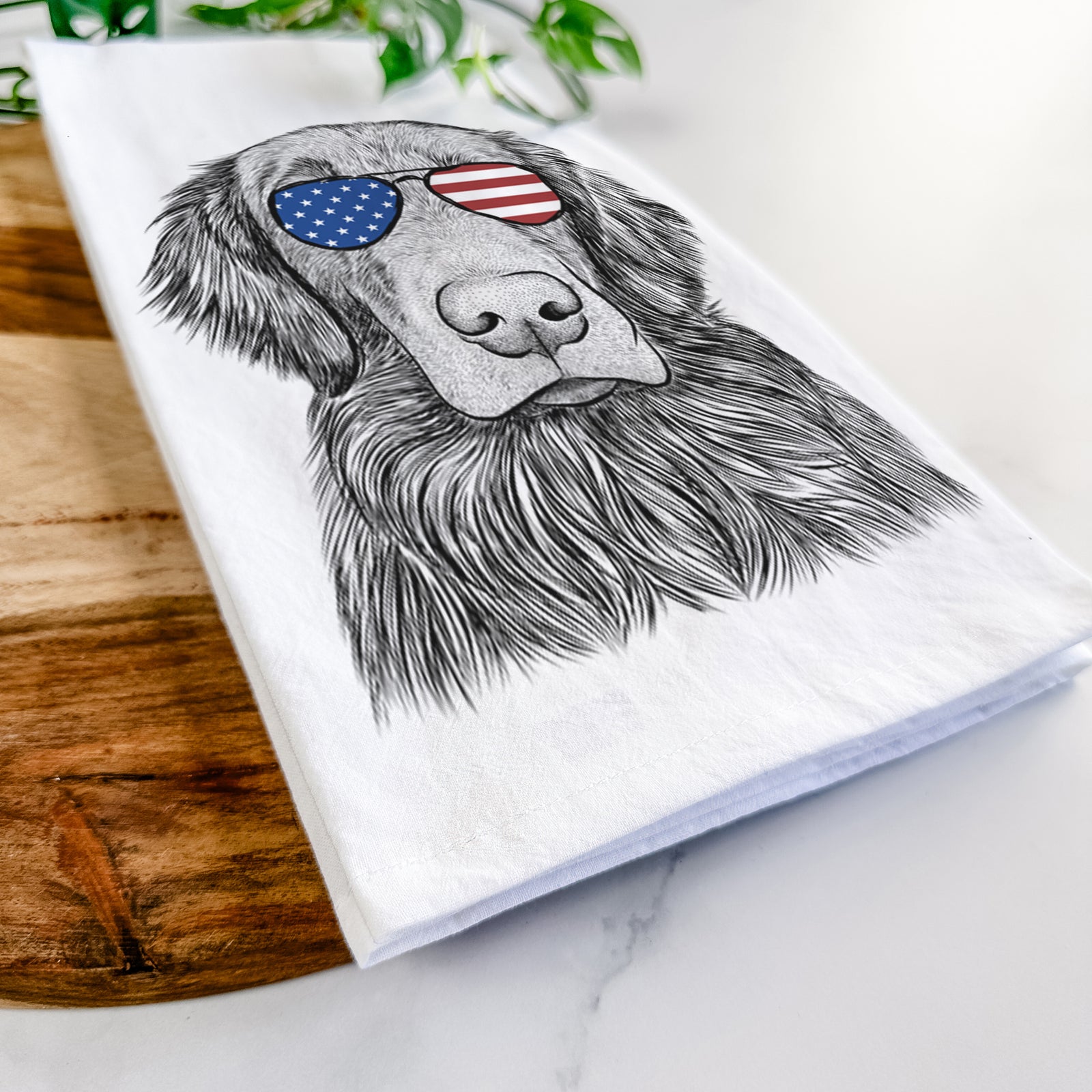 Hand-drawn sketch of Pippin the Flat Coated Retriever wearing American flag sunglasses on a tea towel