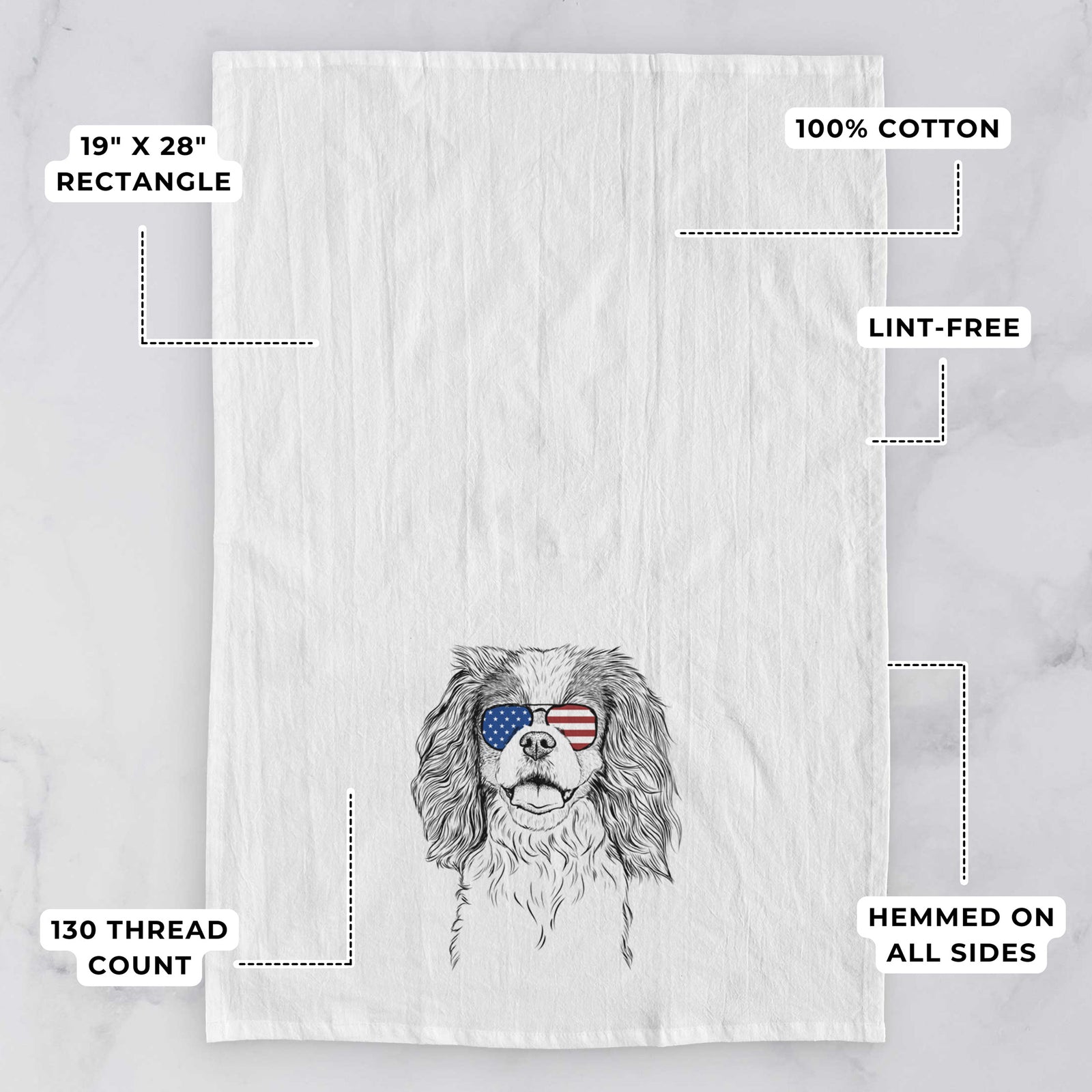 Hand-drawn sketch of Poppy the Cavalier King Charles Spaniel wearing American flag sunglasses on a tea towel, with feature callouts: 19 x 28 inch rectangle, 100% cotton, lint-free, 120 thread count, hemmed on all sides