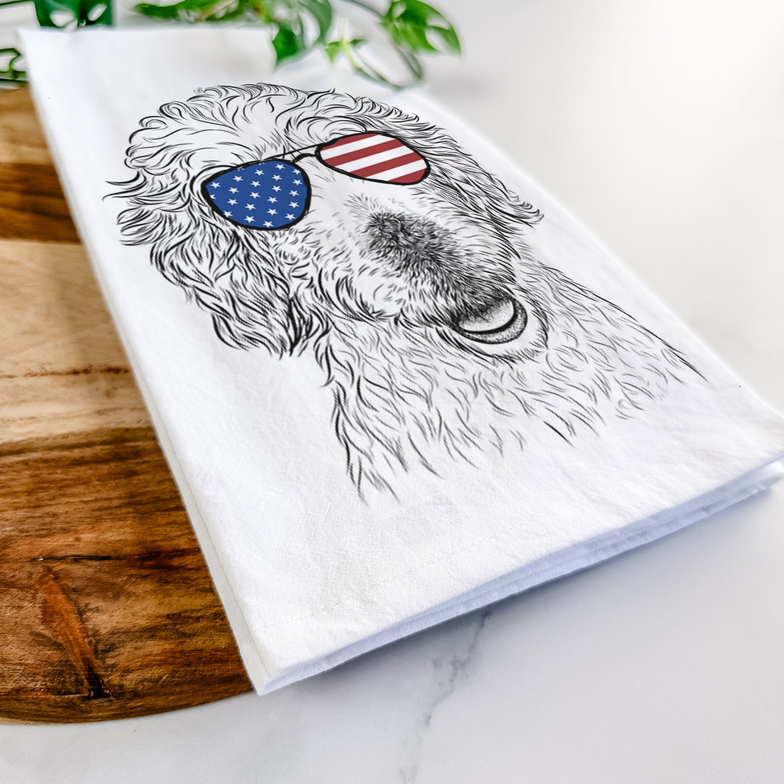 Hand-drawn sketch of Preston the Labradoodle wearing American flag sunglasses on a tea towel