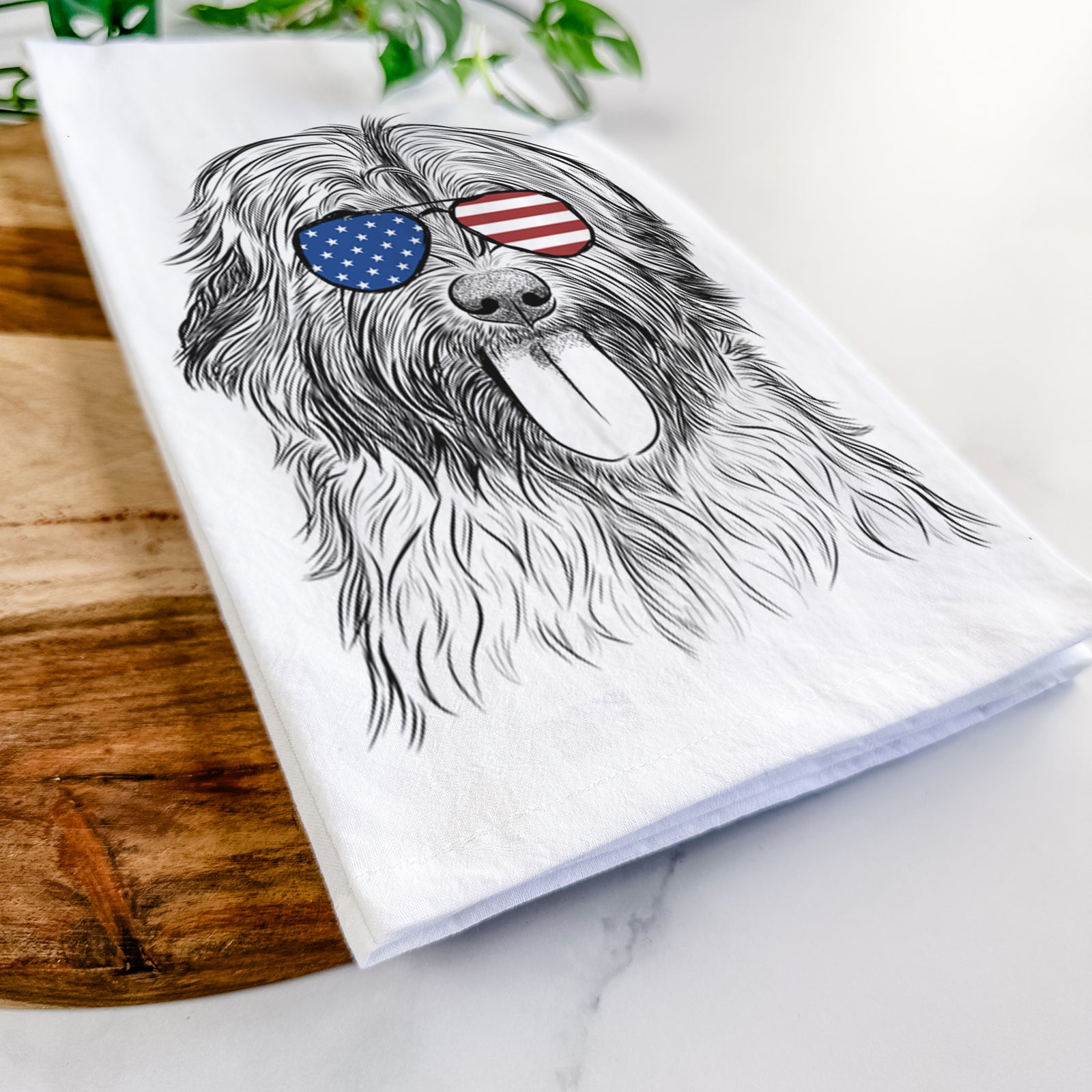 Hand-drawn sketch of Puig the Catalan Sheepdog wearing American flag sunglasses on a tea towel