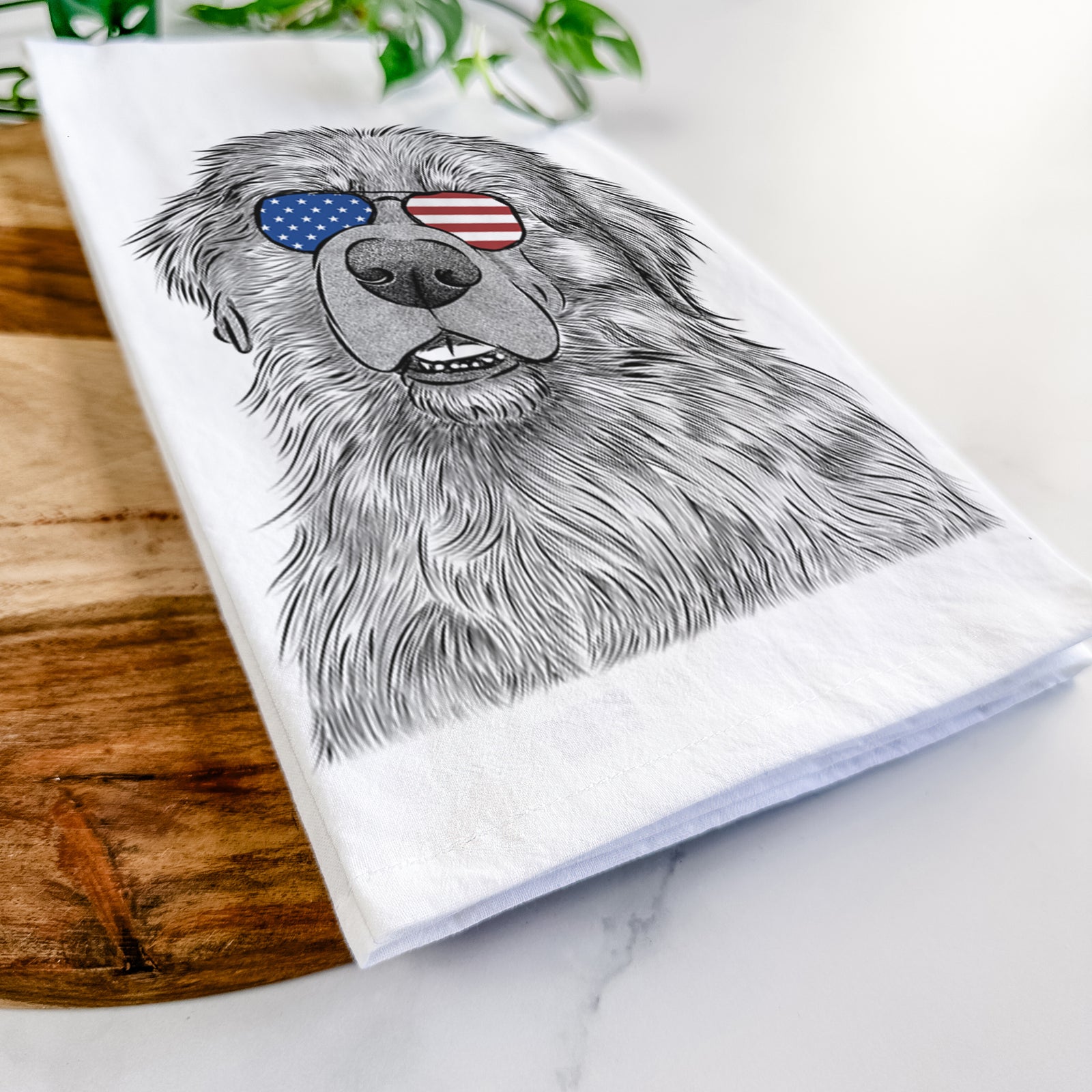 Hand-drawn sketch of Ralph the Leonberger wearing American flag sunglasses on a tea towel