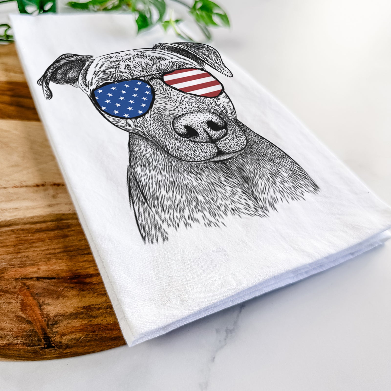 Hand-drawn sketch of Reeses the Pitbull wearing American flag sunglasses on a tea towel