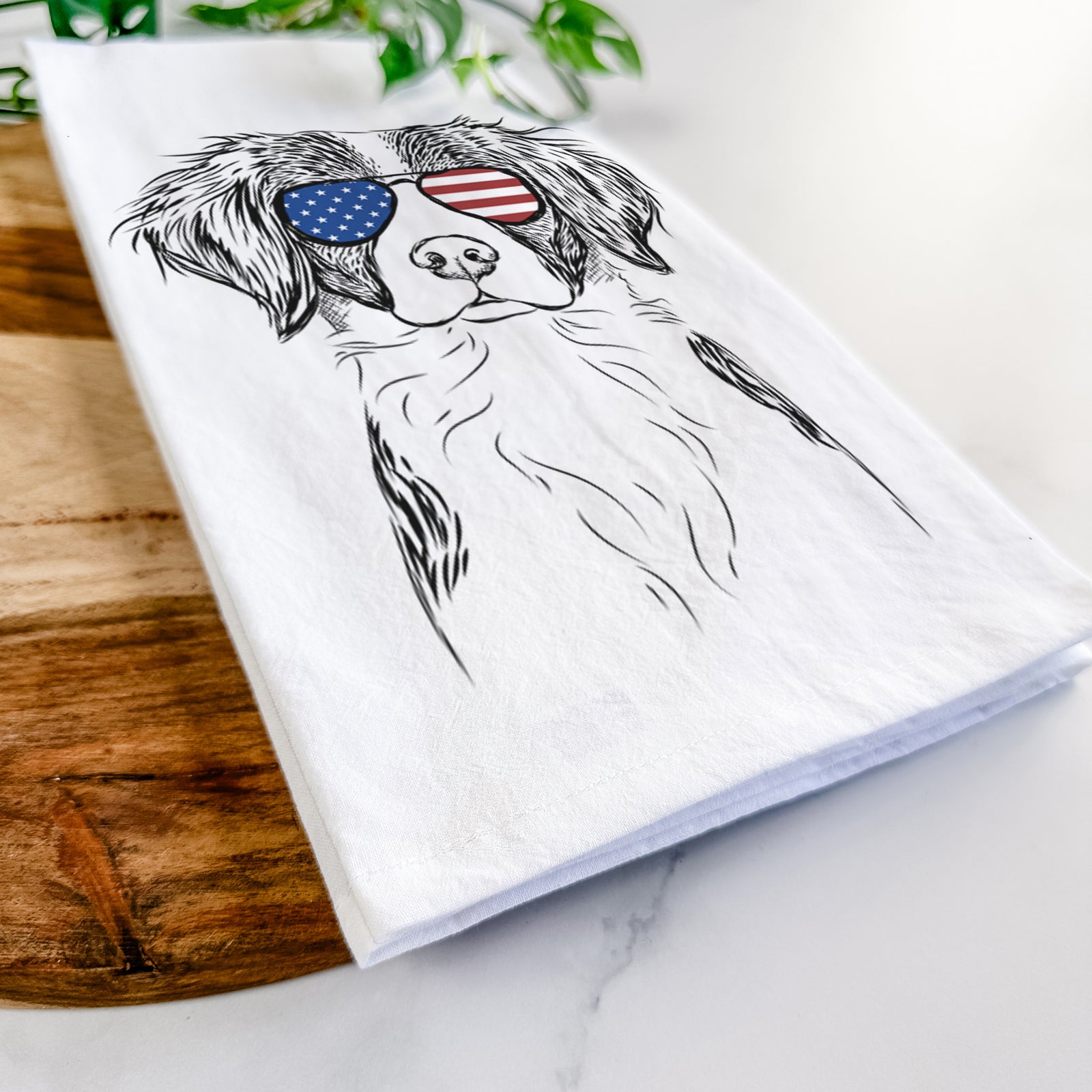 Hand-drawn sketch of Remi the Brittany wearing American flag sunglasses on a tea towel