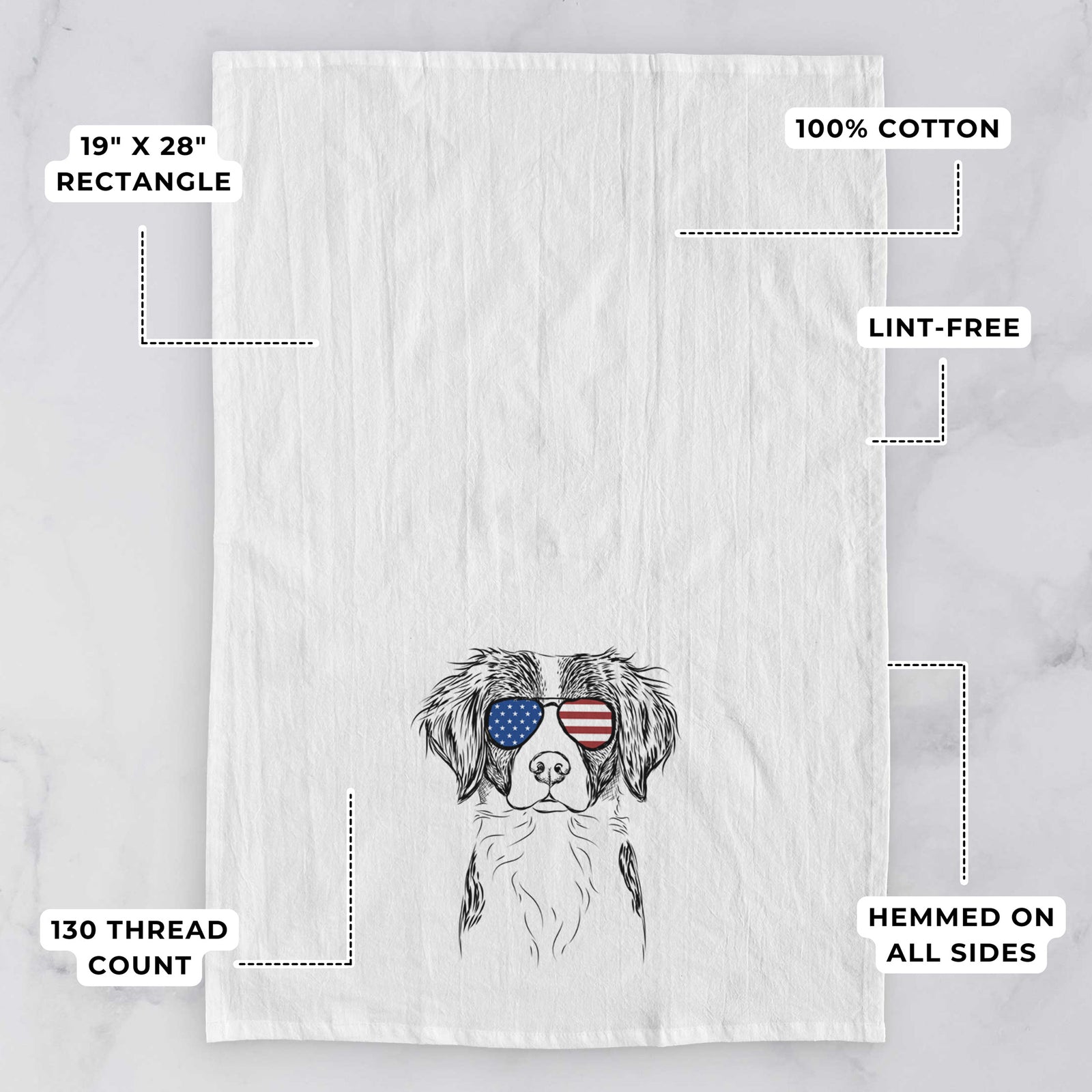 Hand-drawn sketch of Remi the Brittany wearing American flag sunglasses on a tea towel, with feature callouts: 19 x 28 inch rectangle, 100% cotton, lint-free, 120 thread count, hemmed on all sides