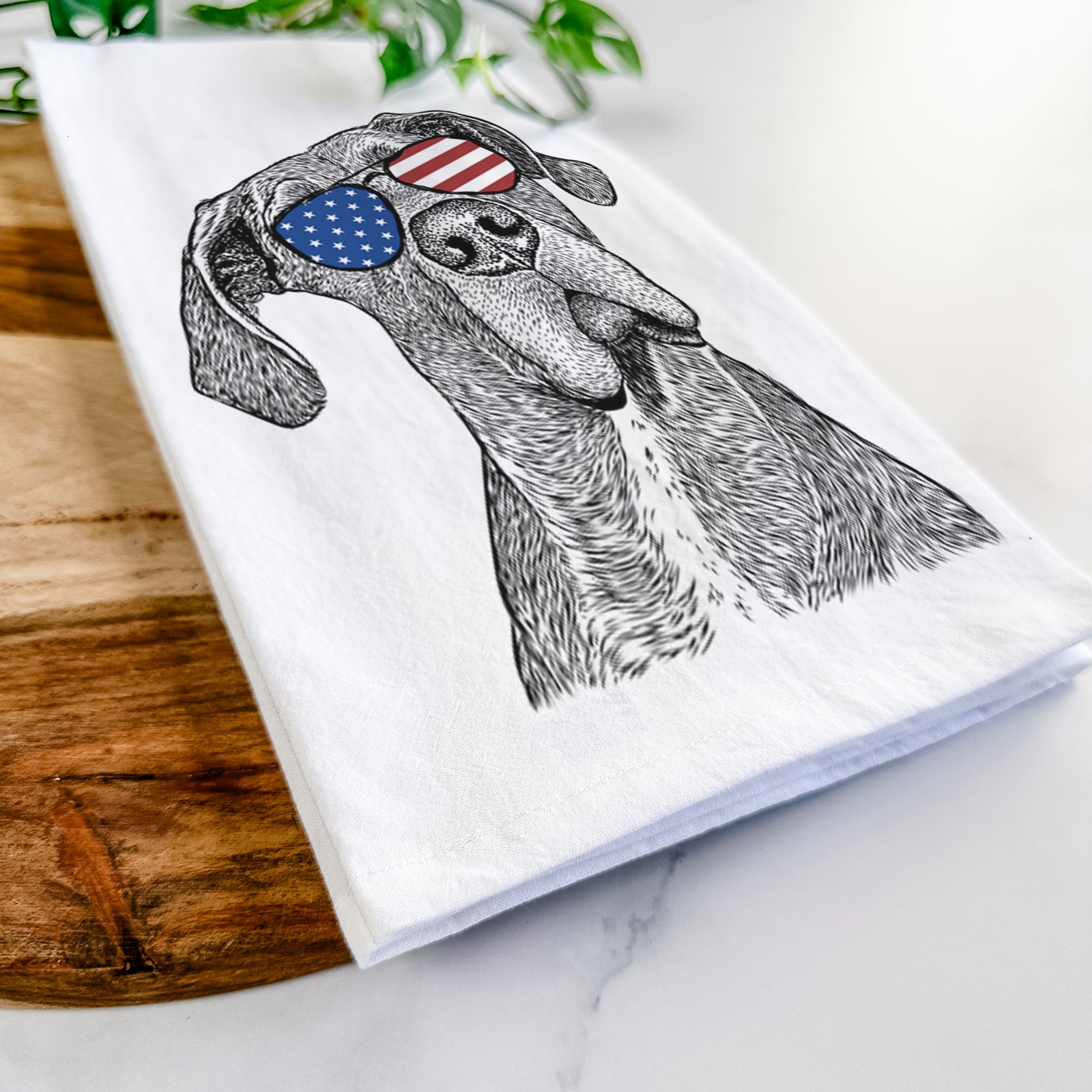 Hand-drawn sketch of River the Great Dane wearing American flag sunglasses on a tea towel