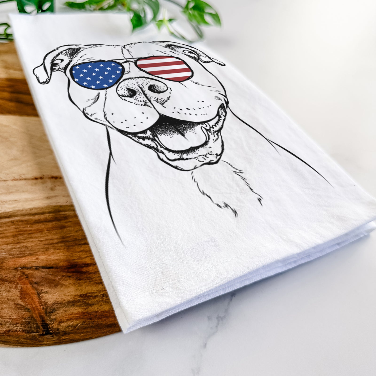Hand-drawn sketch of Roscoe the Pitbull wearing American flag sunglasses on a tea towel