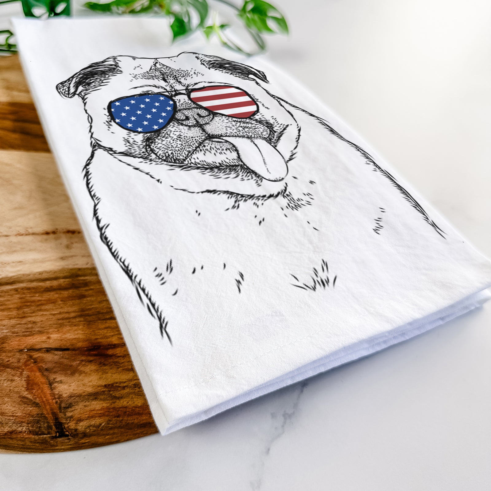 Hand-drawn sketch of Rosie the Pug wearing American flag sunglasses on a tea towel