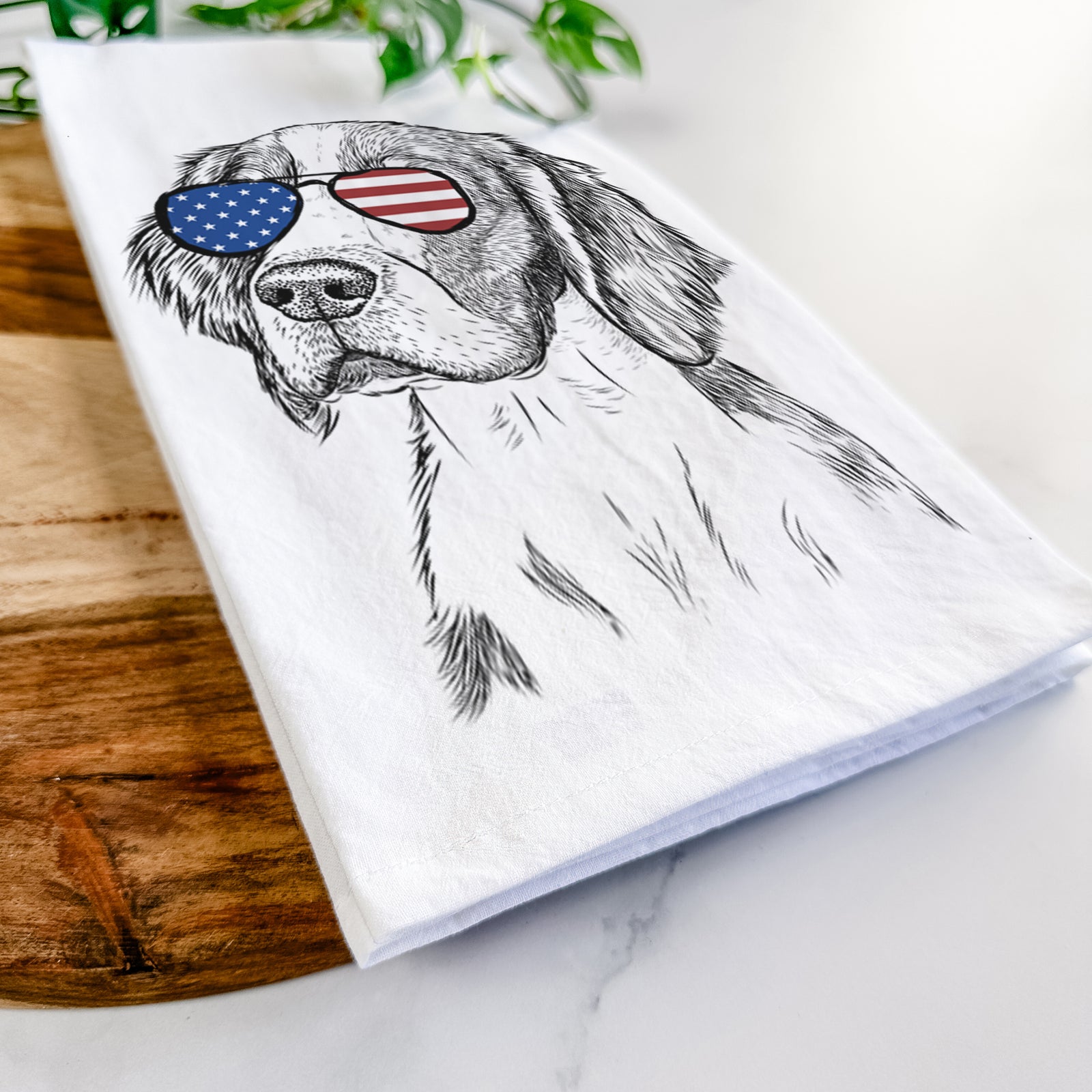 Hand-drawn sketch of Roxy the Welsh Springer Spaniel wearing American flag sunglasses on a tea towel