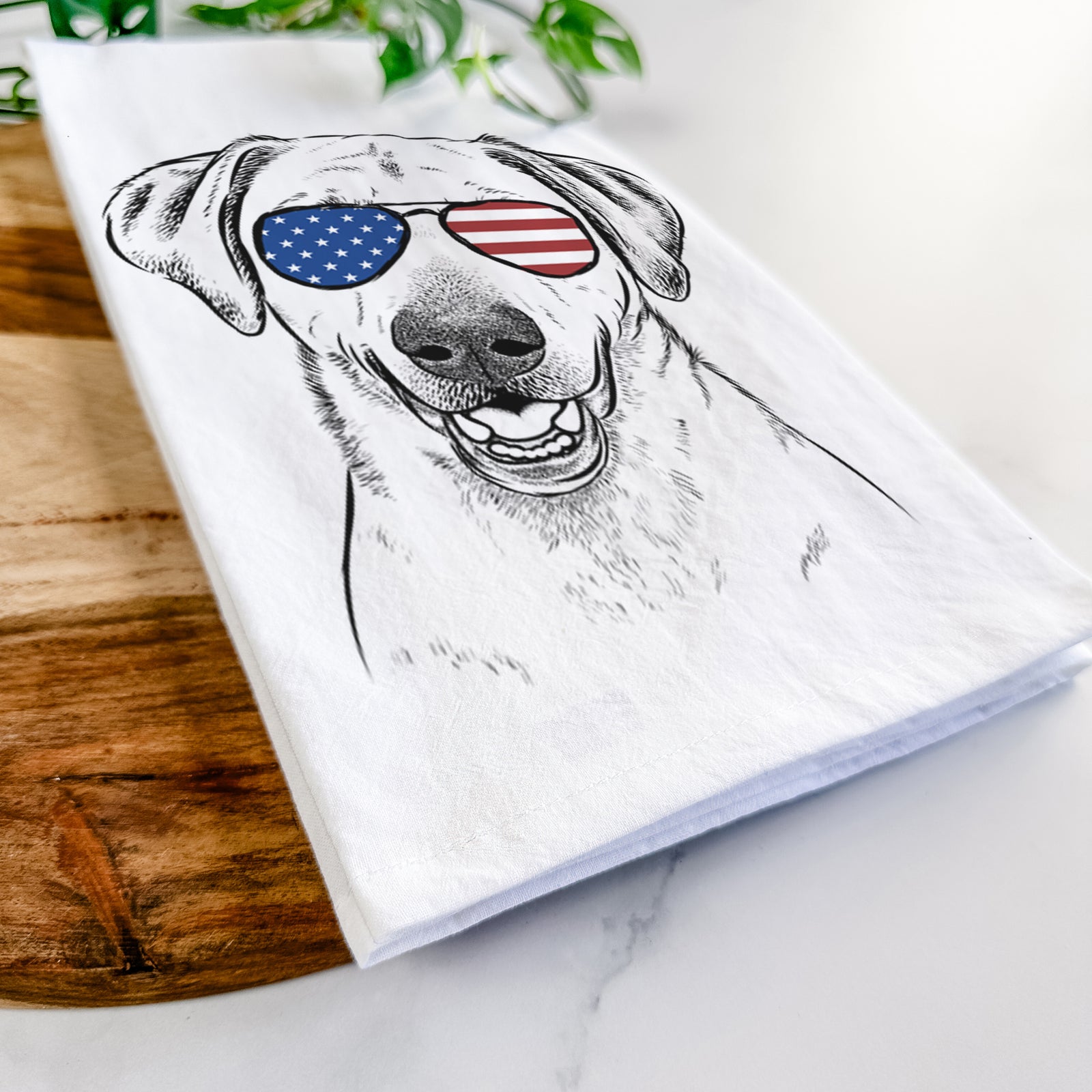 Hand-drawn sketch of Rusty the Labrador Retriever wearing American flag sunglasses on a tea towel