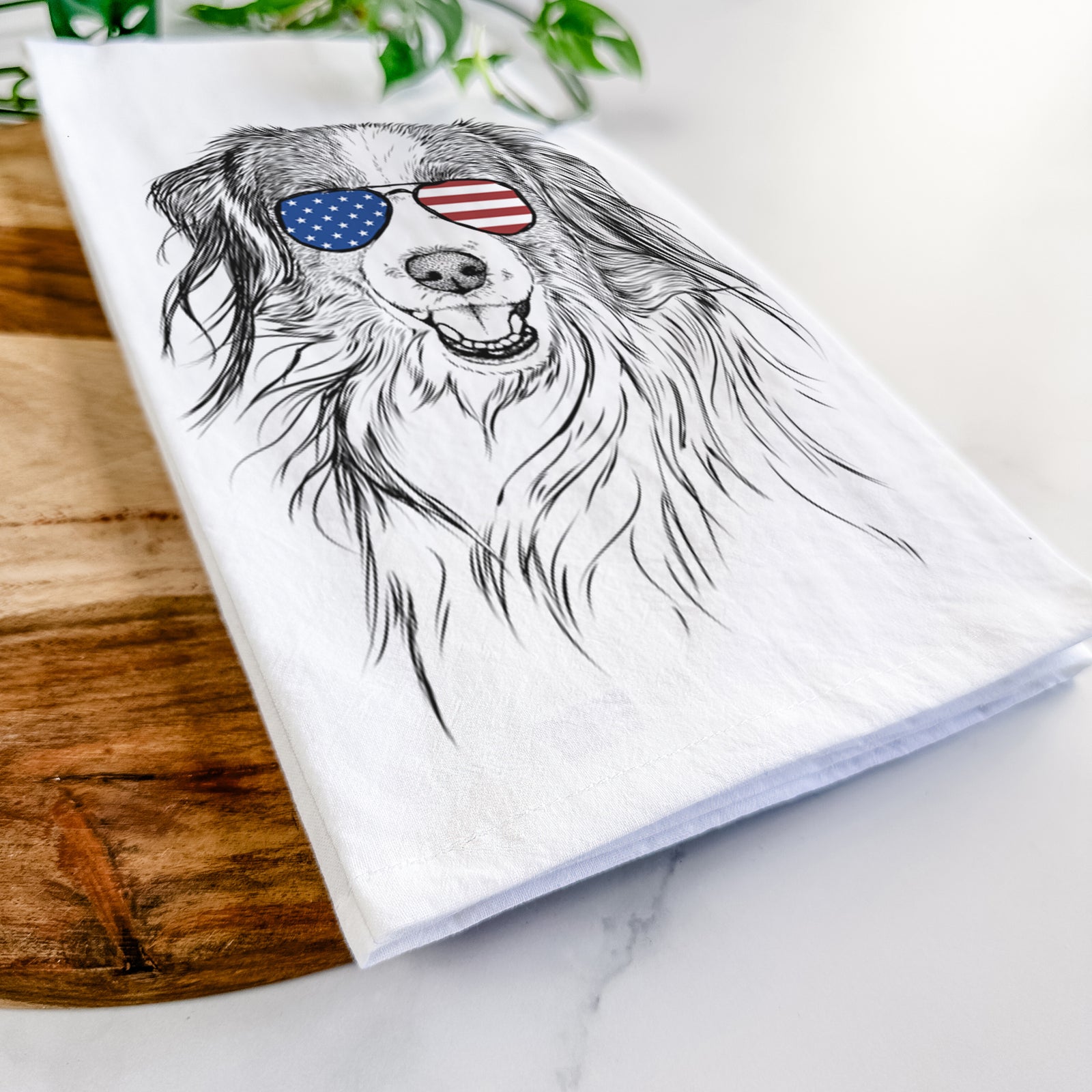 Hand-drawn sketch of Rutger the Nederlandse Kooikerhondje wearing American flag sunglasses on a tea towel