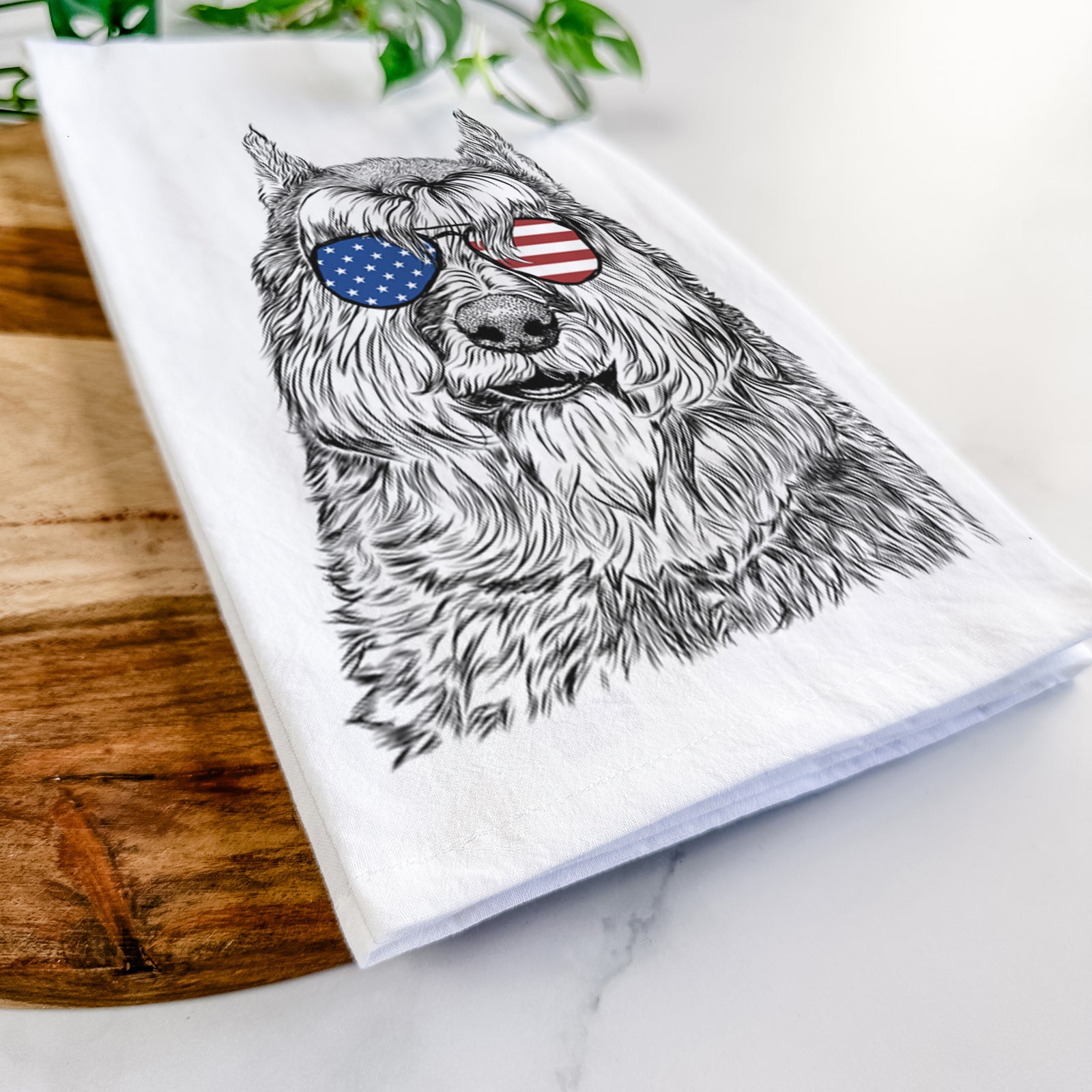 Hand-drawn sketch of Sabre the Bouvier Des Flandres wearing American flag sunglasses on a tea towel