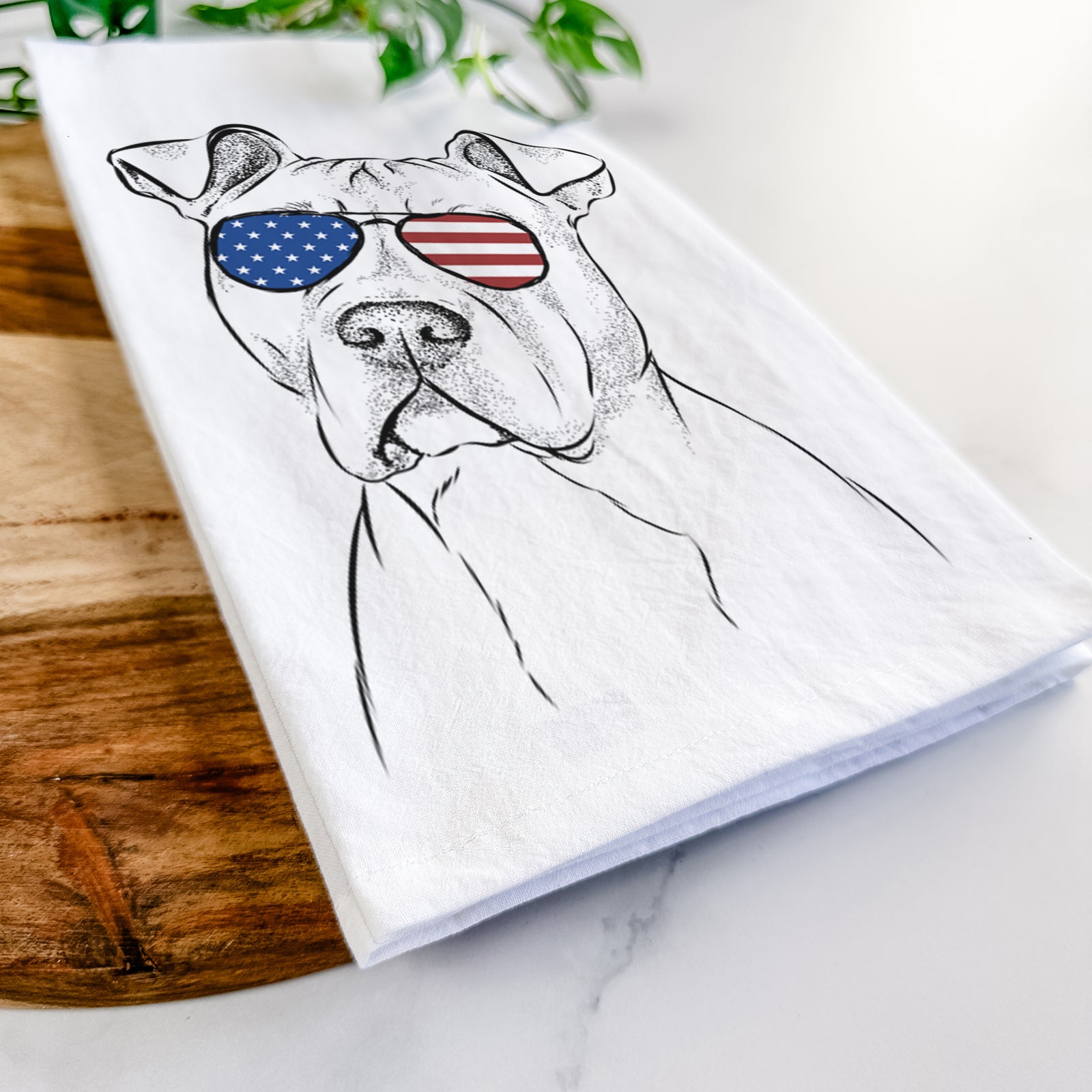 Hand-drawn sketch of Scraps the American Staffordshire Mix wearing American flag sunglasses on a tea towel