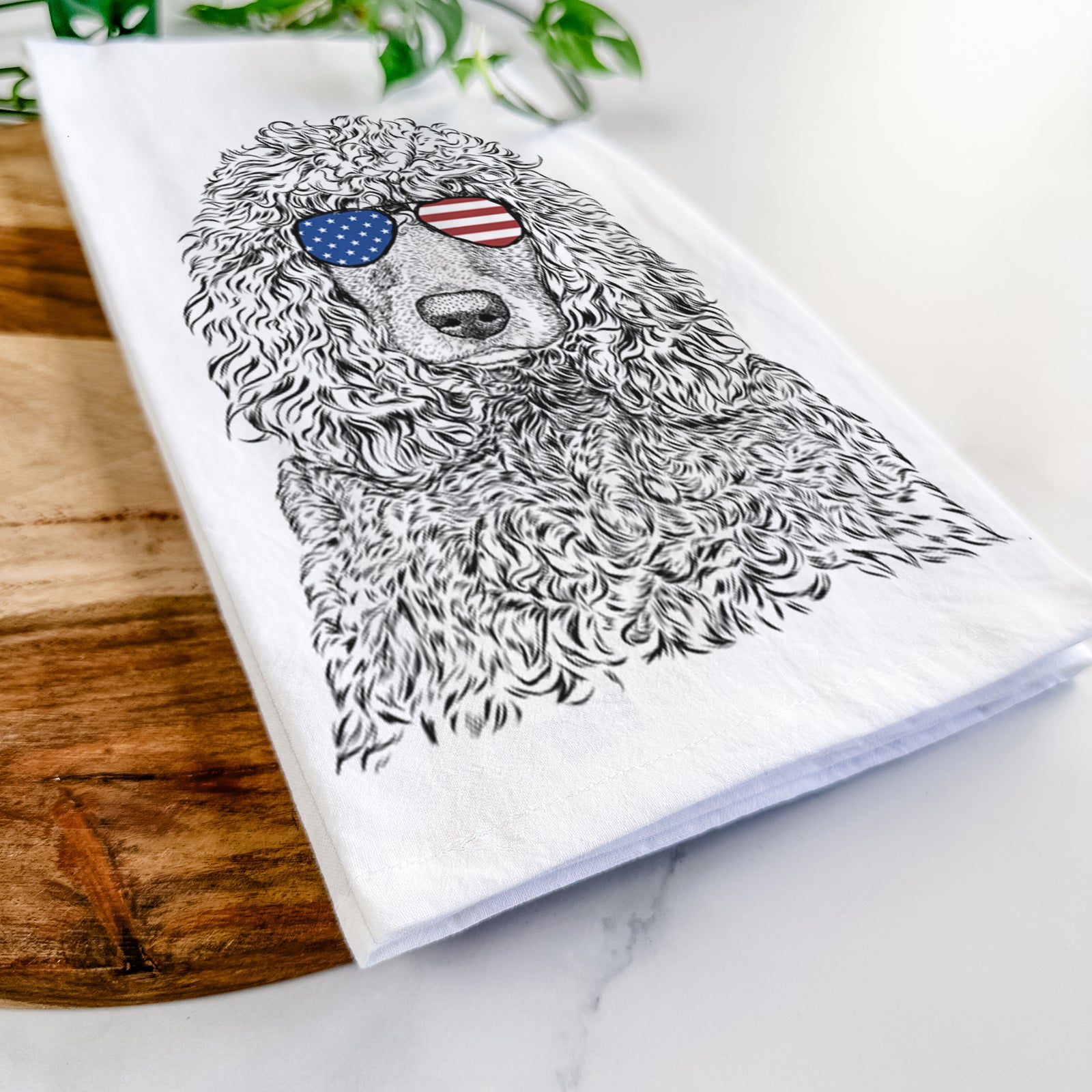 Hand-drawn sketch of Shilo the Irish Water Spaniel wearing American flag sunglasses on a tea towel