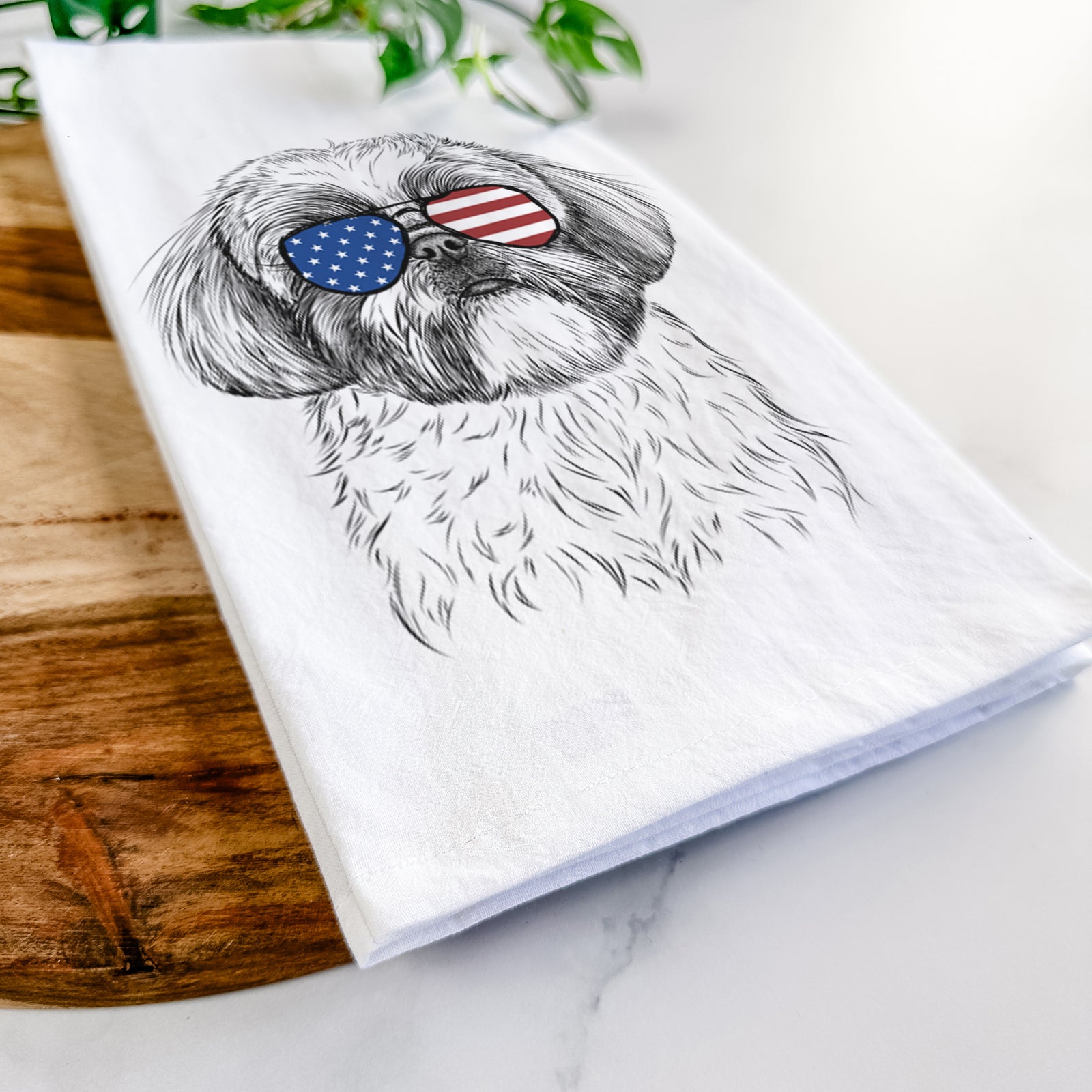 Hand-drawn sketch of Simon the Shih Tzu wearing American flag sunglasses on a tea towel