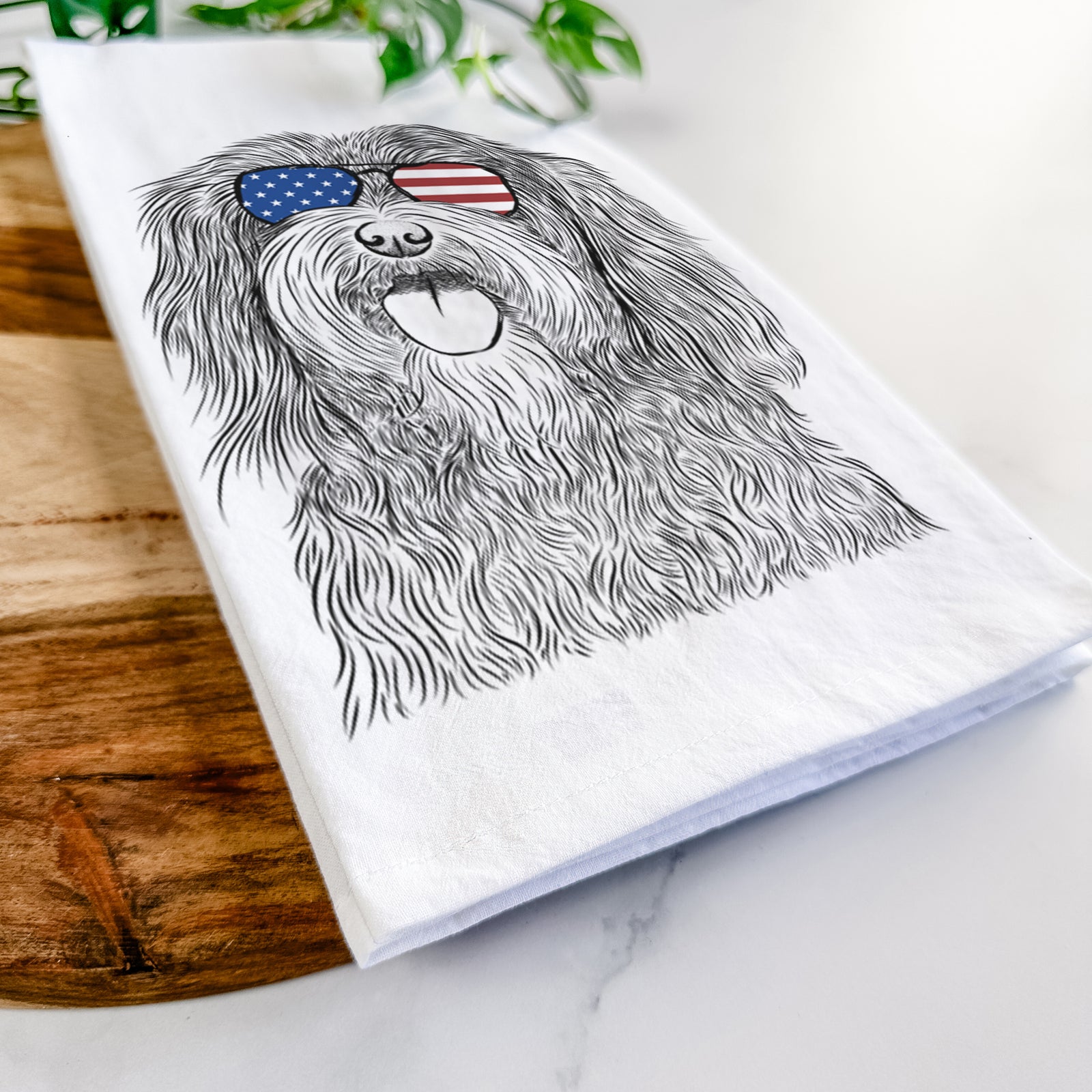 Hand-drawn sketch of Sophie the Havanese wearing American flag sunglasses on a tea towel