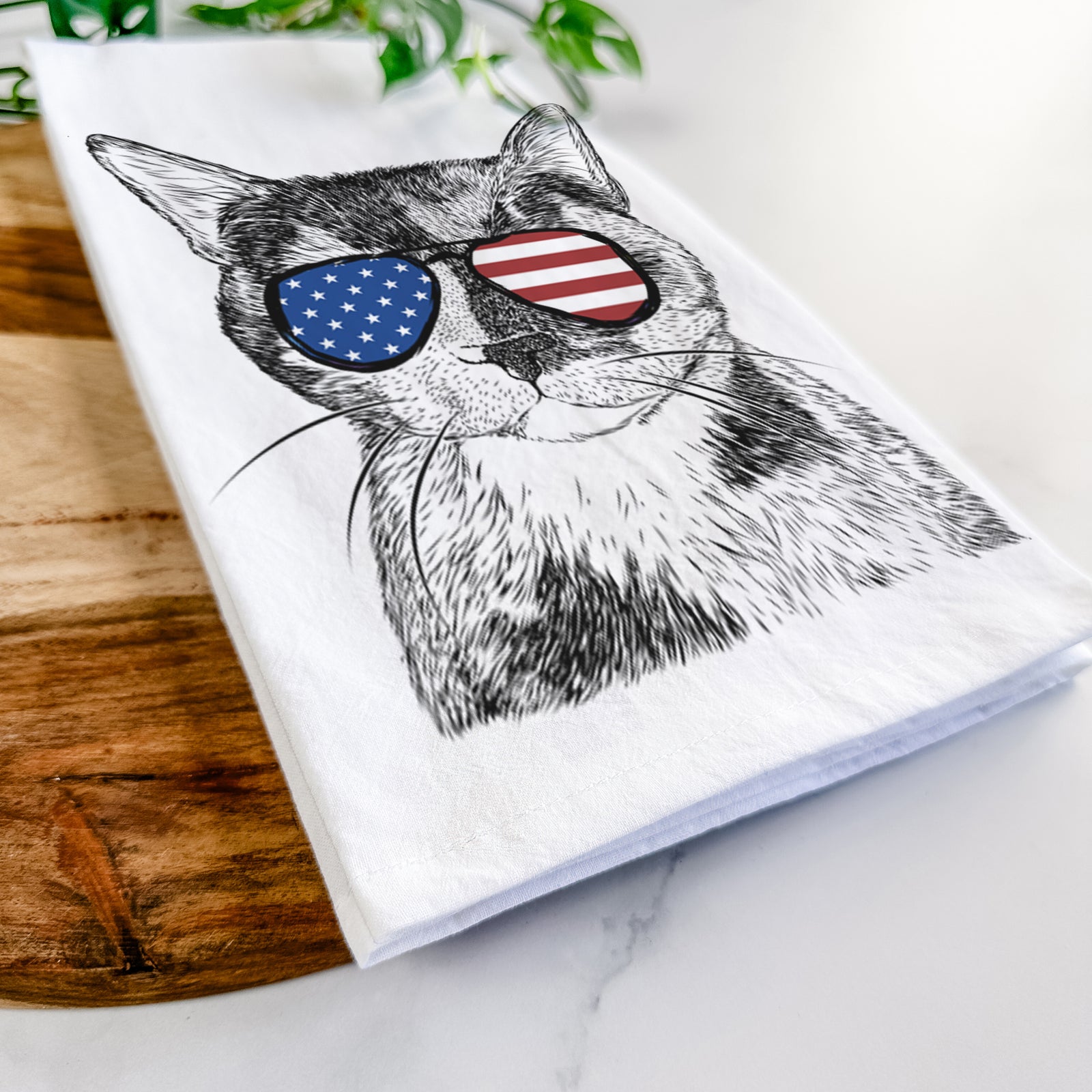 Hand-drawn sketch of Spooky Kitty the Tortoiseshell Cat wearing American flag sunglasses on a tea towel