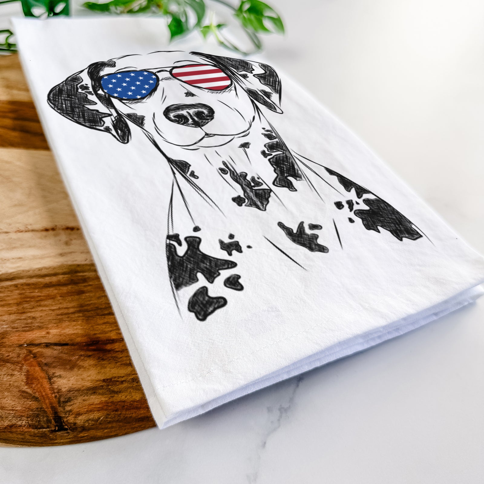 Hand-drawn sketch of Spot the Dalmatian wearing American flag sunglasses on a tea towel