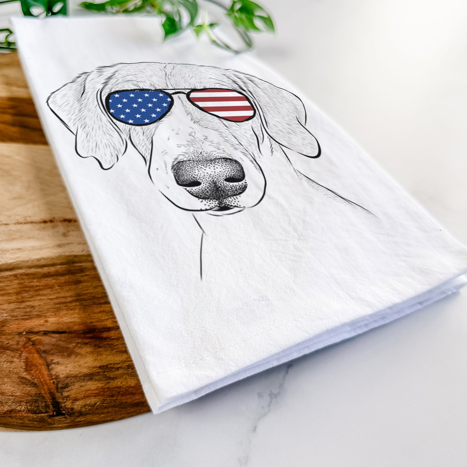 Hand-drawn sketch of Stanley the Foxhound wearing American flag sunglasses on a tea towel