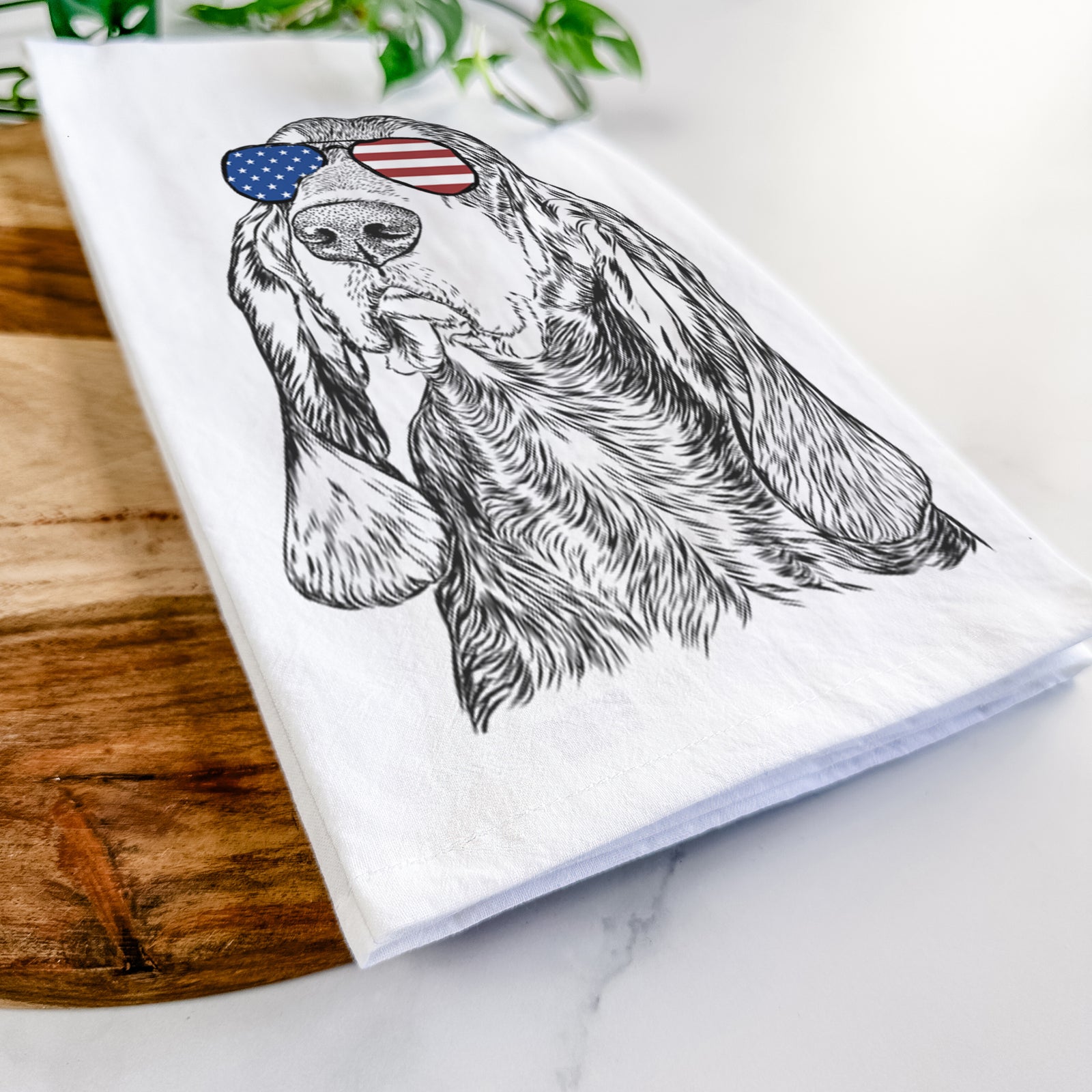 Hand-drawn sketch of Stu the Black and Tan Coonhound wearing American flag sunglasses on a tea towel