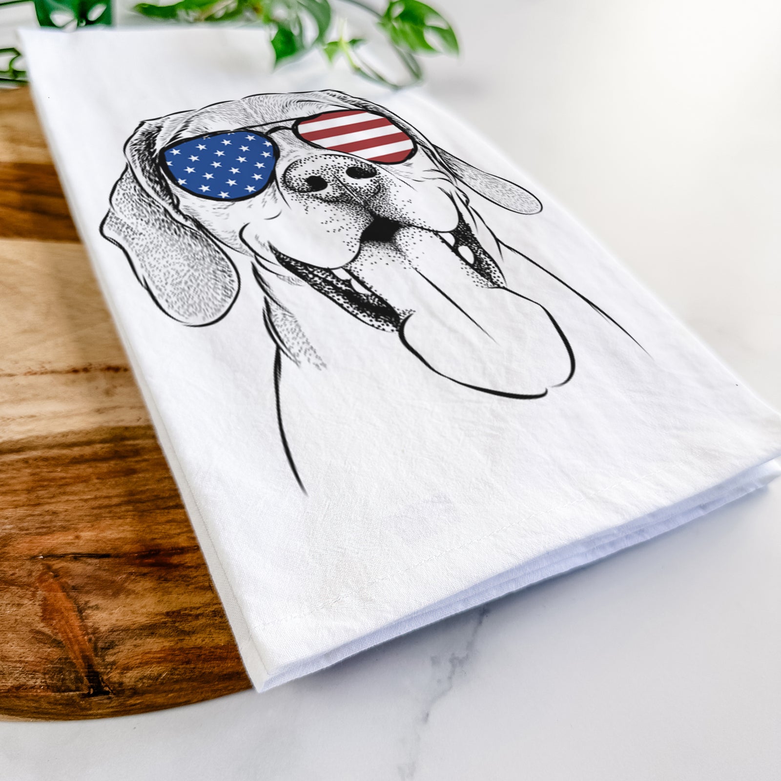 Hand-drawn sketch of Sunny the Beagle wearing American flag sunglasses on a tea towel