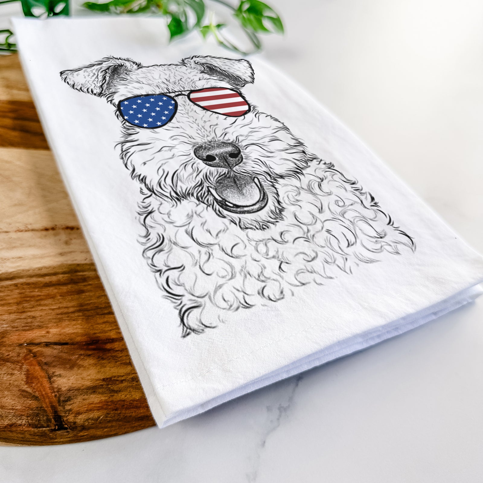 Hand-drawn sketch of Ted the Wire Fox Terrier wearing American flag sunglasses on a tea towel