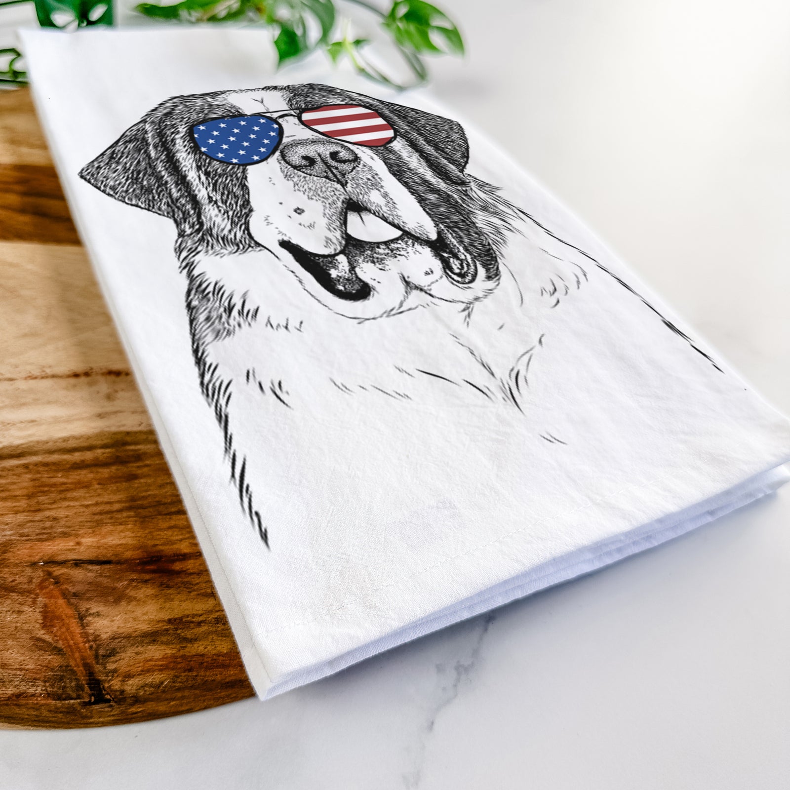 Hand-drawn sketch of Thor the Saint Bernard wearing American flag sunglasses on a tea towel