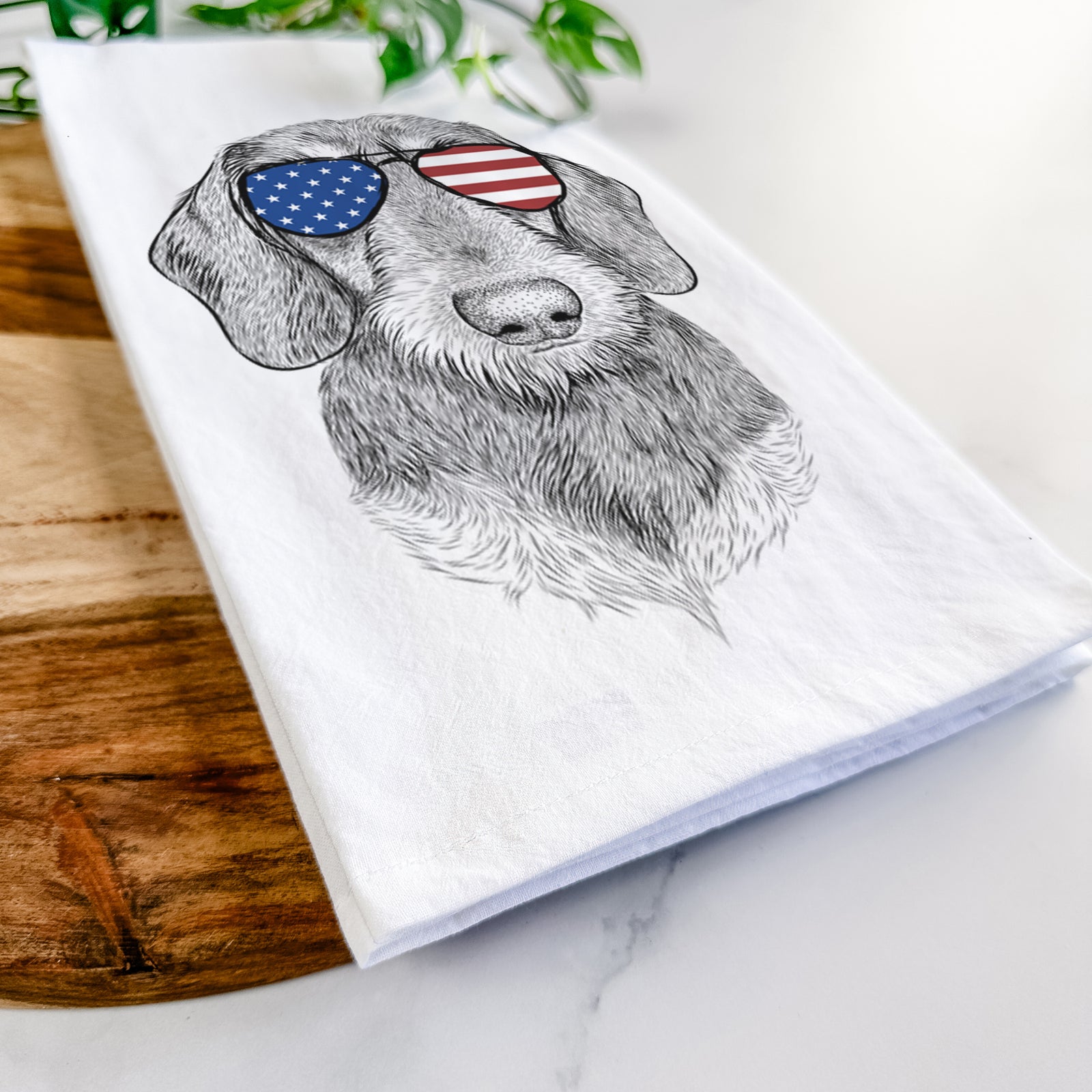 Hand-drawn sketch of Truman the Wirehaired Dachshund wearing American flag sunglasses on a tea towel