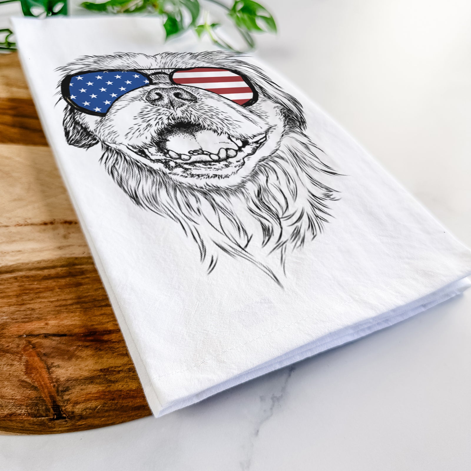 Hand-drawn sketch of Wally the Pekingese wearing American flag sunglasses on a tea towel