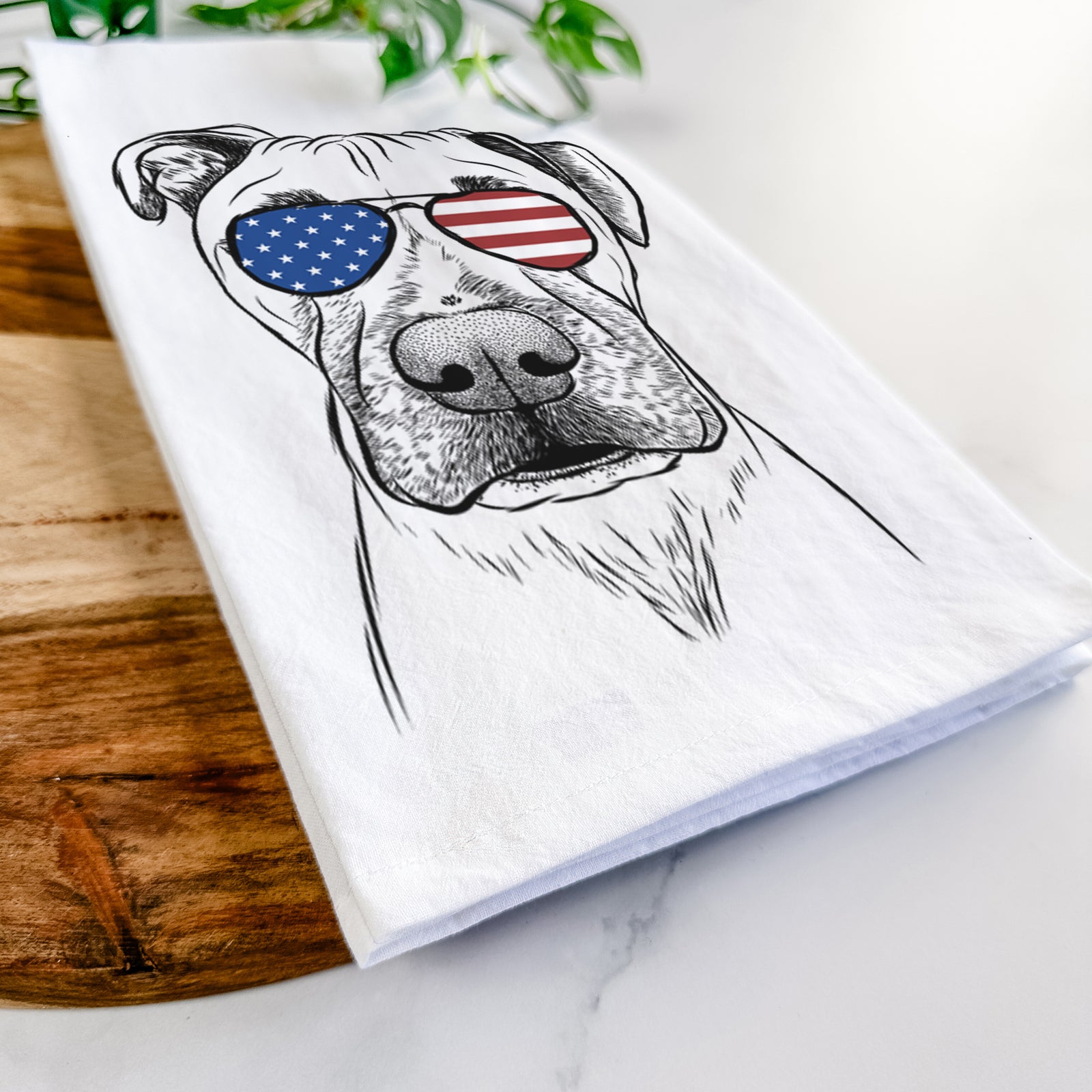 Hand-drawn sketch of Waylon the Boxane wearing American flag sunglasses on a tea towel
