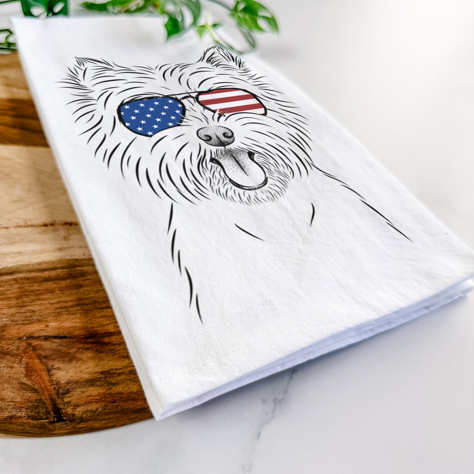 Hand-drawn sketch of Welma the West Highland Terrier wearing American flag sunglasses on a tea towel