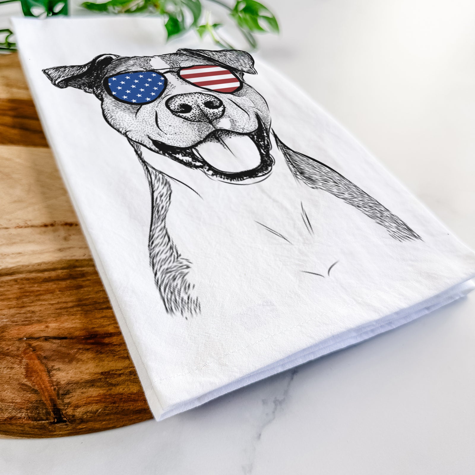 Hand-drawn sketch of Wendy the Mixed Breed wearing American flag sunglasses on a tea towel