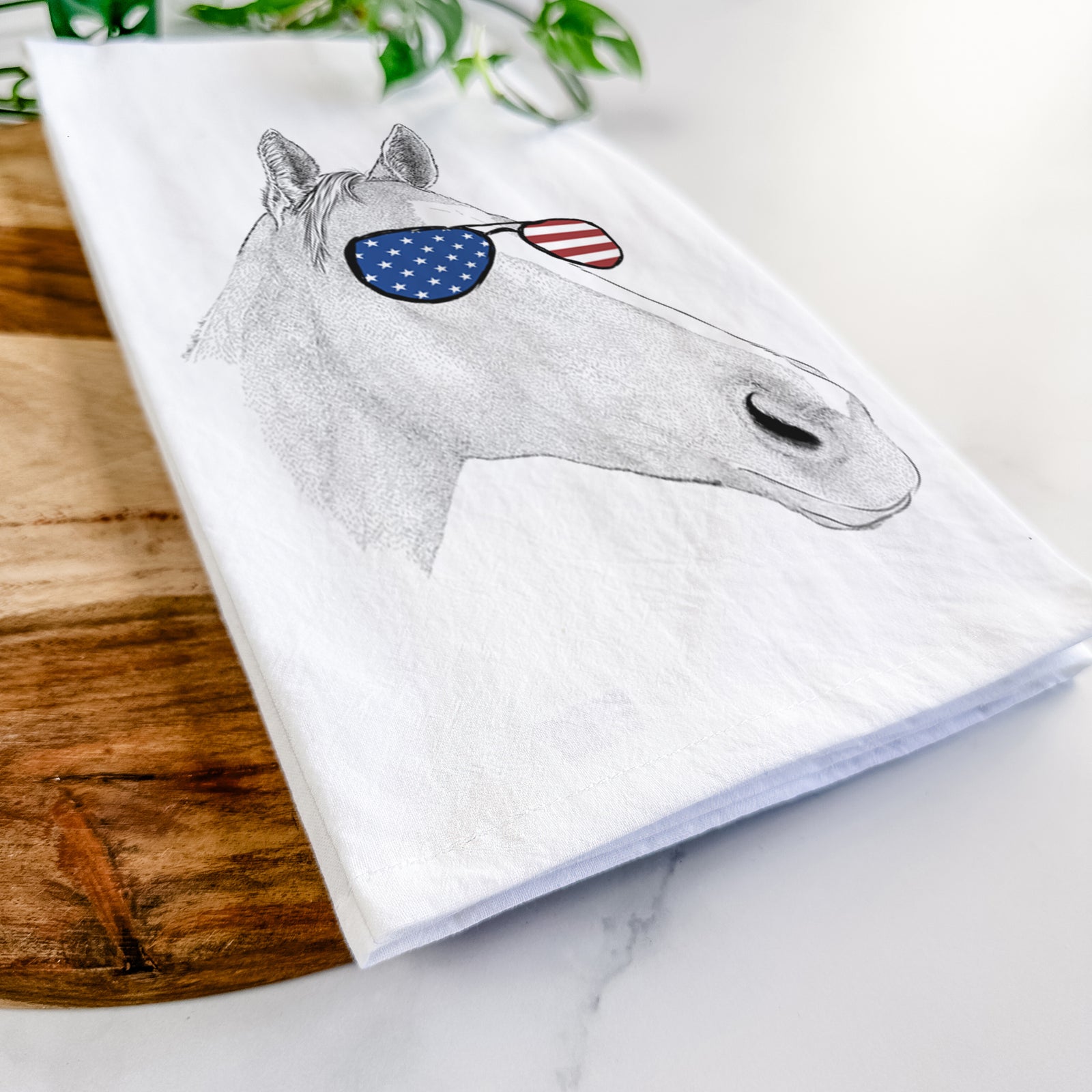 Hand-drawn sketch of Westley the Horse wearing American flag sunglasses on a tea towel