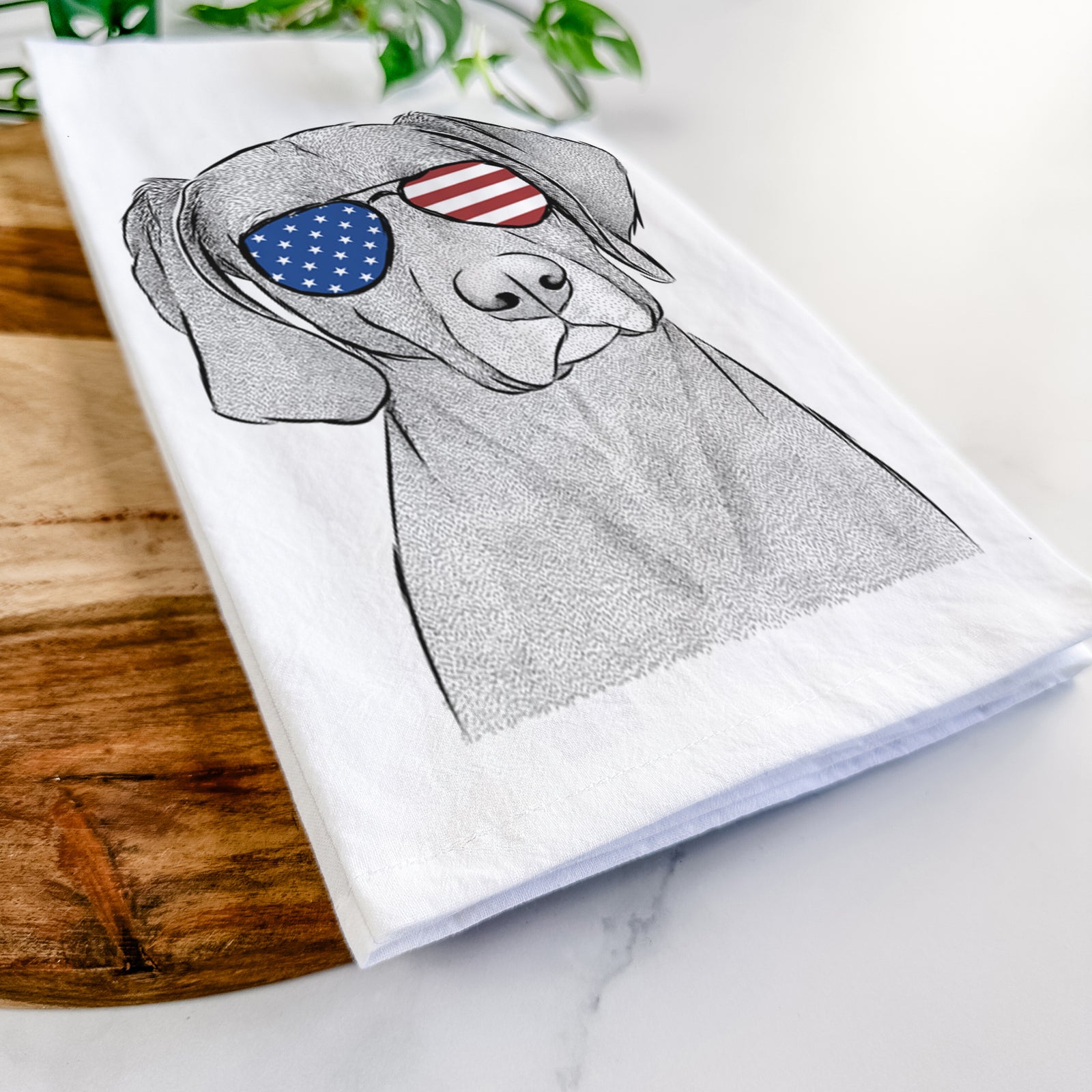Hand-drawn sketch of Willow the Weizsla wearing American flag sunglasses on a tea towel