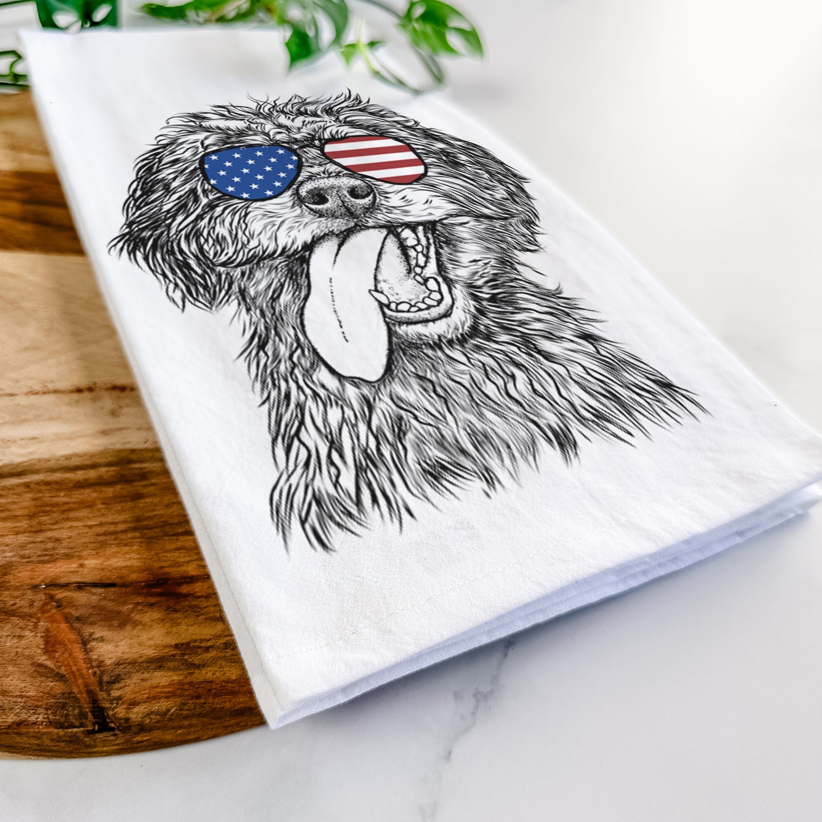 Hand-drawn sketch of Winnie the Mini Aussiedoodle wearing American flag sunglasses on a tea towel