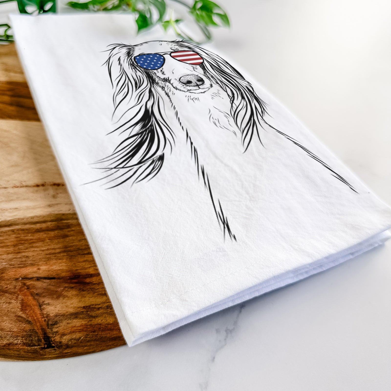 Hand-drawn sketch of Zahra the Saluki wearing American flag sunglasses on a tea towel