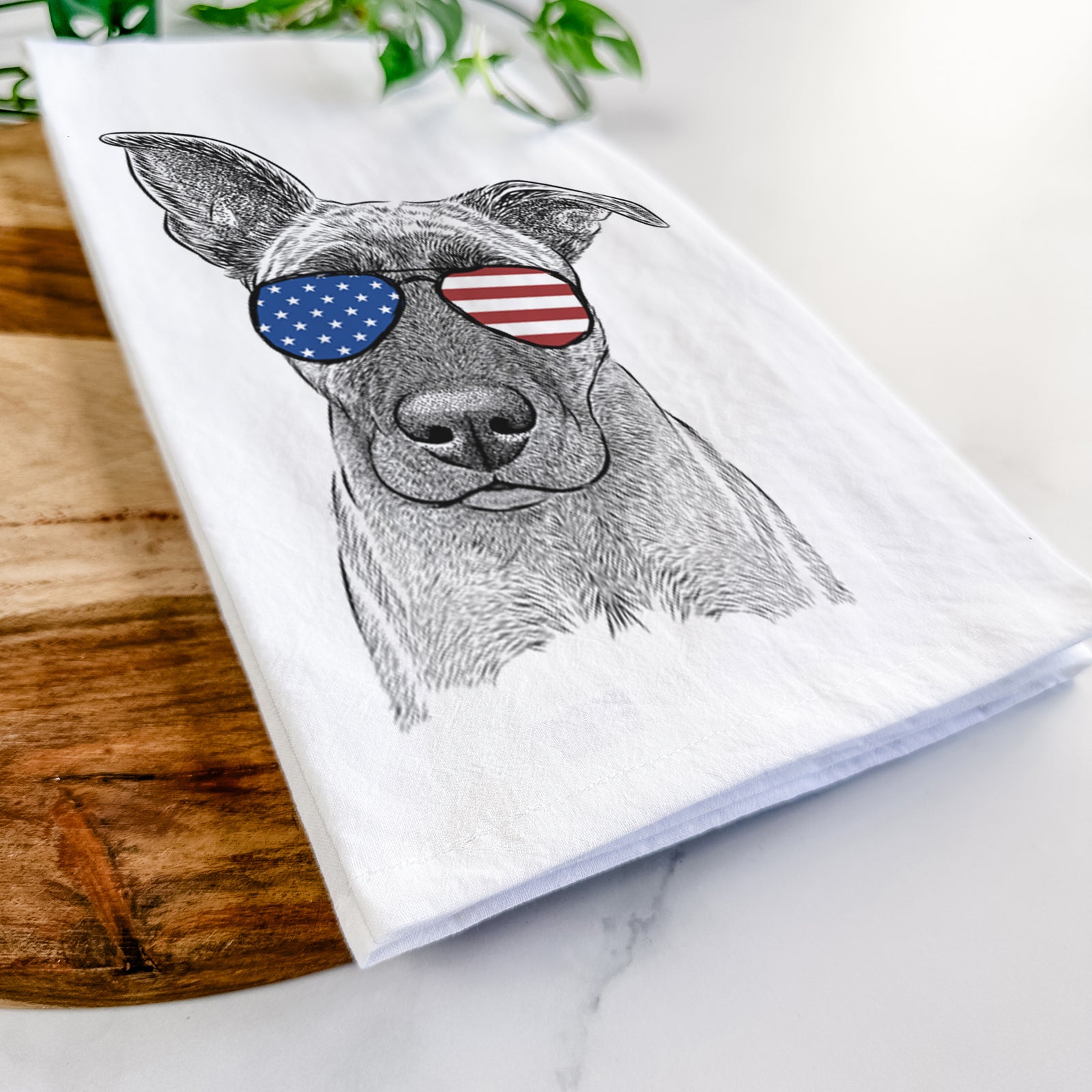 Hand-drawn sketch of Zoey the Mixed Breed wearing American flag sunglasses on a tea towel